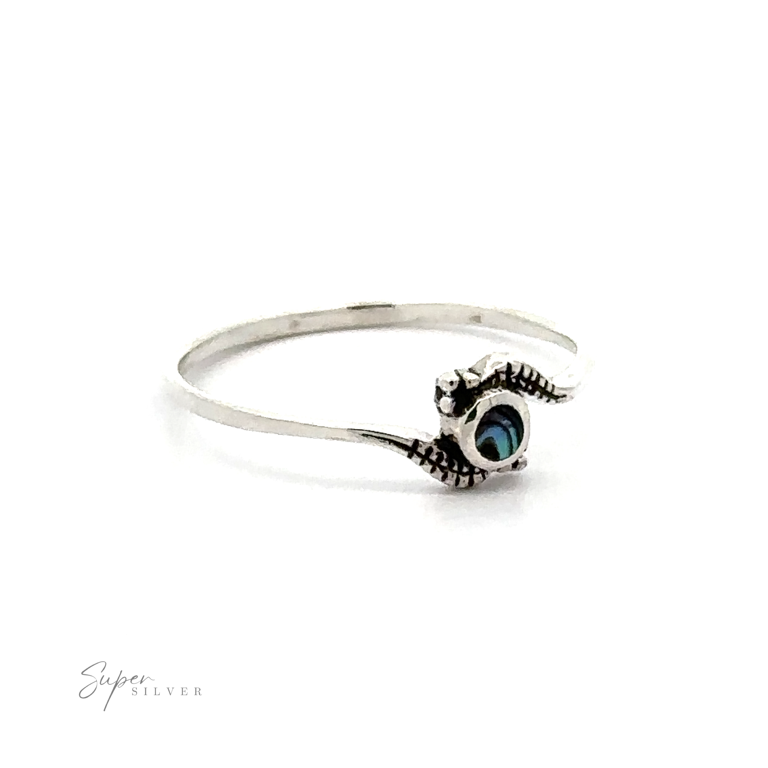 A Tiny Freeform Ring with a Round Inlaid Turquoise Stone and decorative eye motif against a white background.