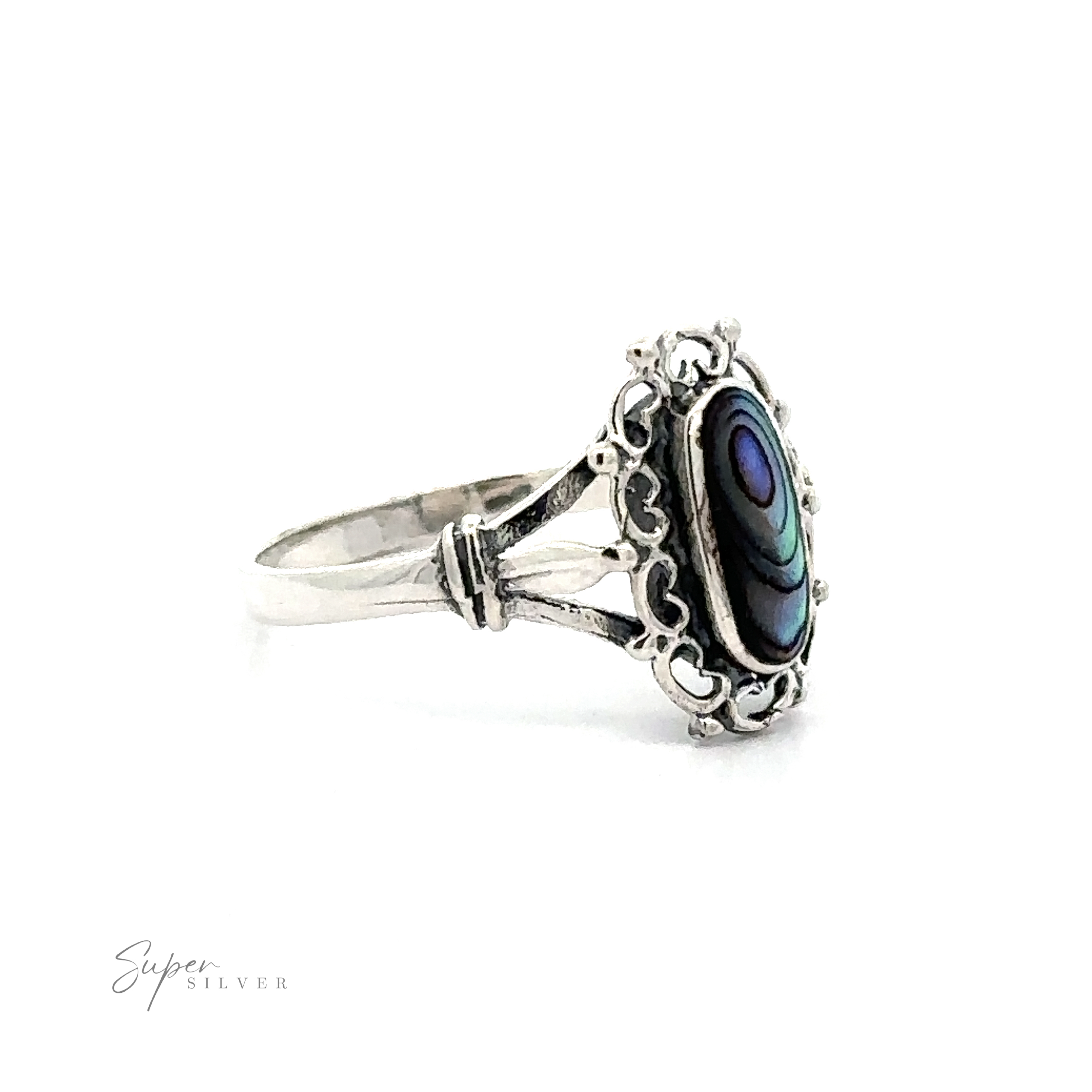 A Inlaid Oval Ring with Filigree Heart Border with abalone shell, giving it a vintage appeal.