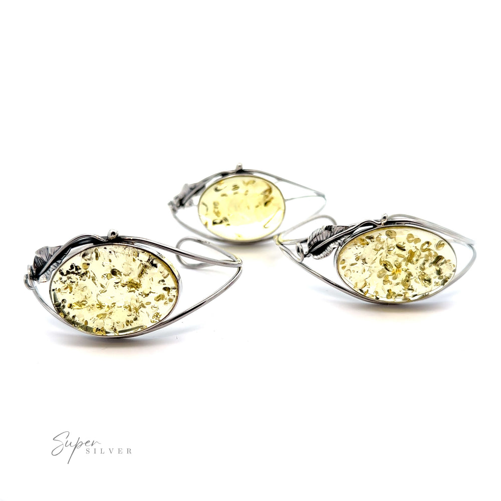 
                  
                    A statement pair of silver earrings with a Delicate Floral Amber Cuff.
                  
                