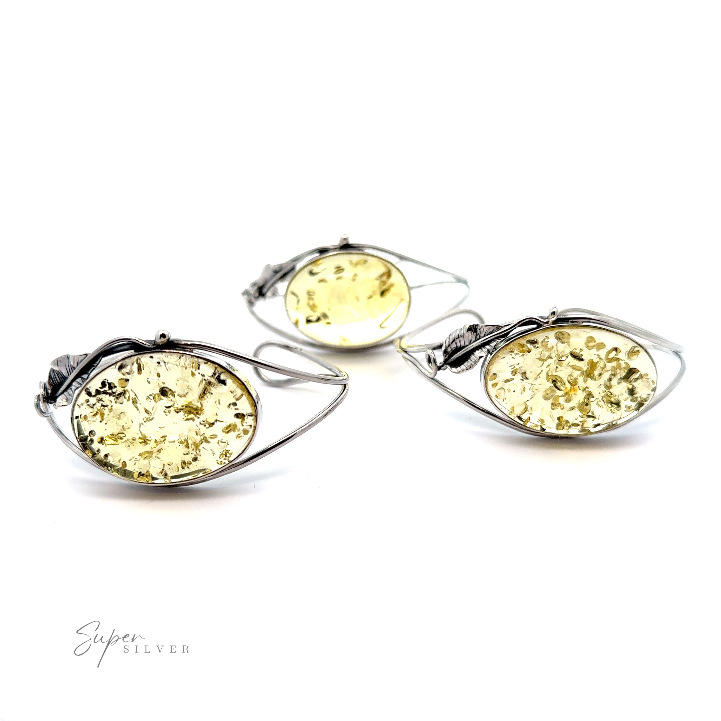 A statement pair of silver earrings with a Delicate Floral Amber Cuff.