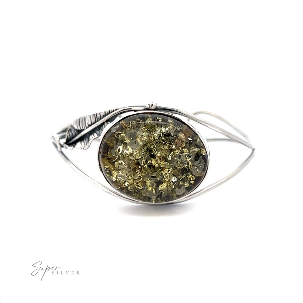 
                  
                    A Delicate Floral Amber Cuff bracelet with a green stone.
                  
                