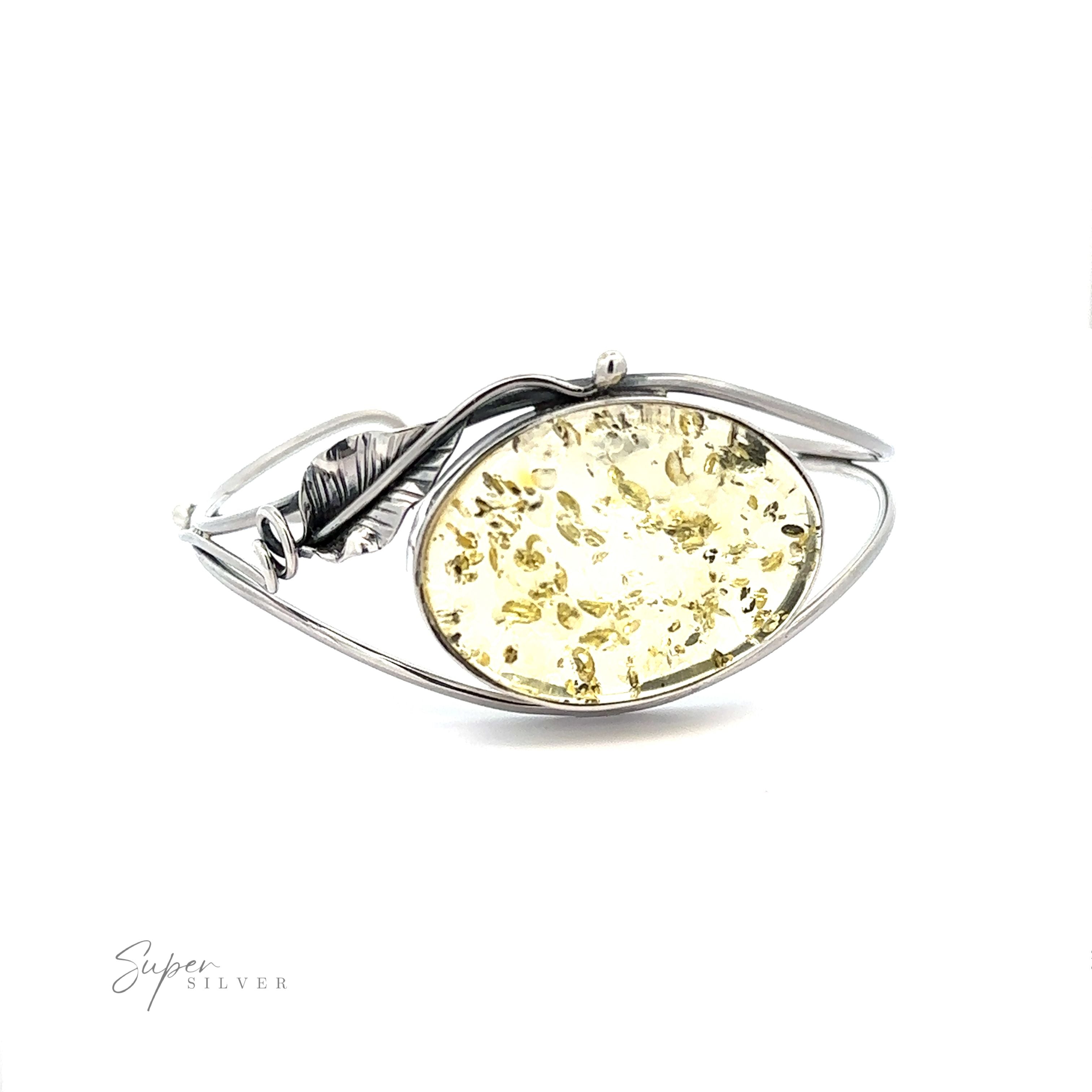 A Delicate Floral Amber Cuff featuring a stunning oval amber stone.