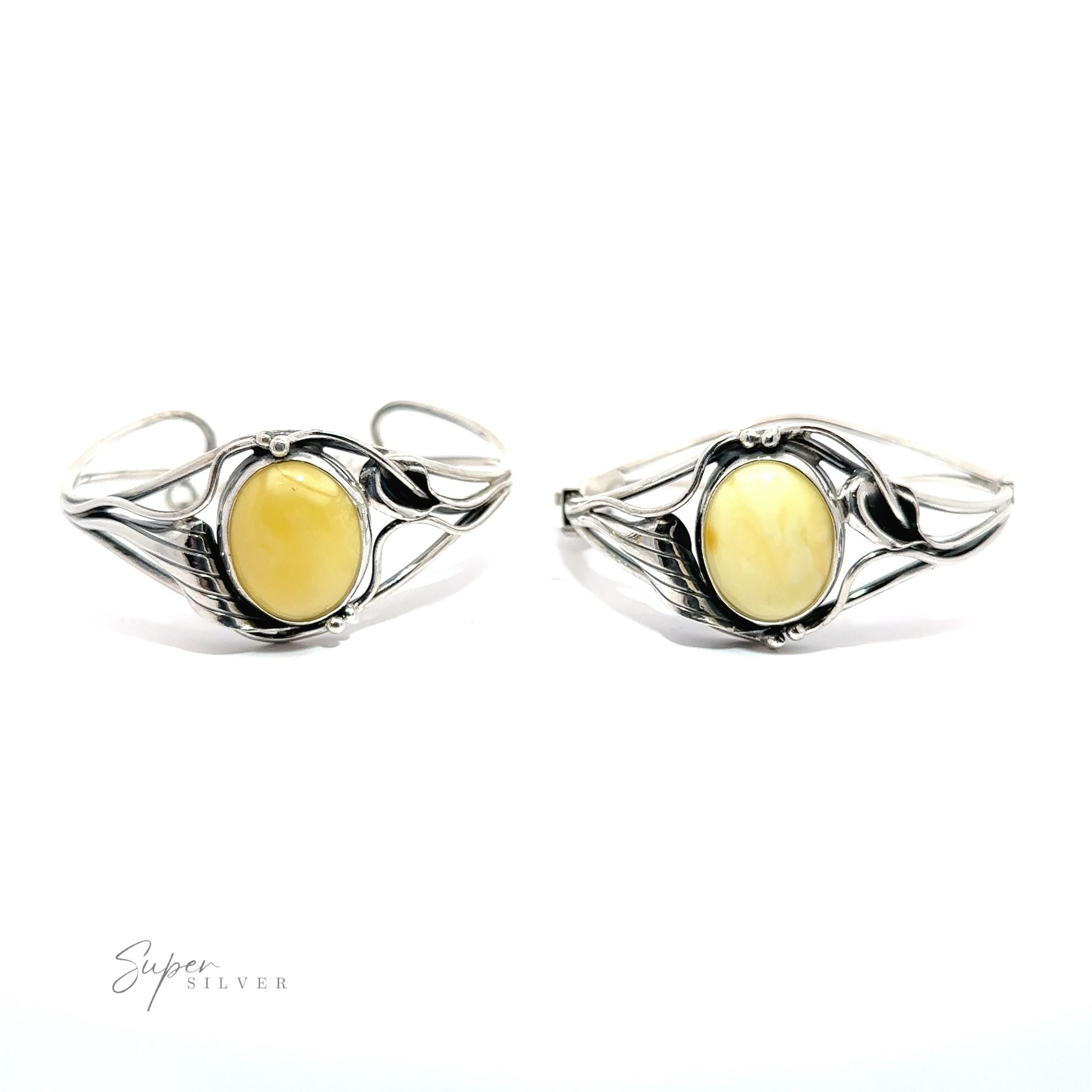 A pair of Butterscotch Amber Bracelets with Nature Detailing.