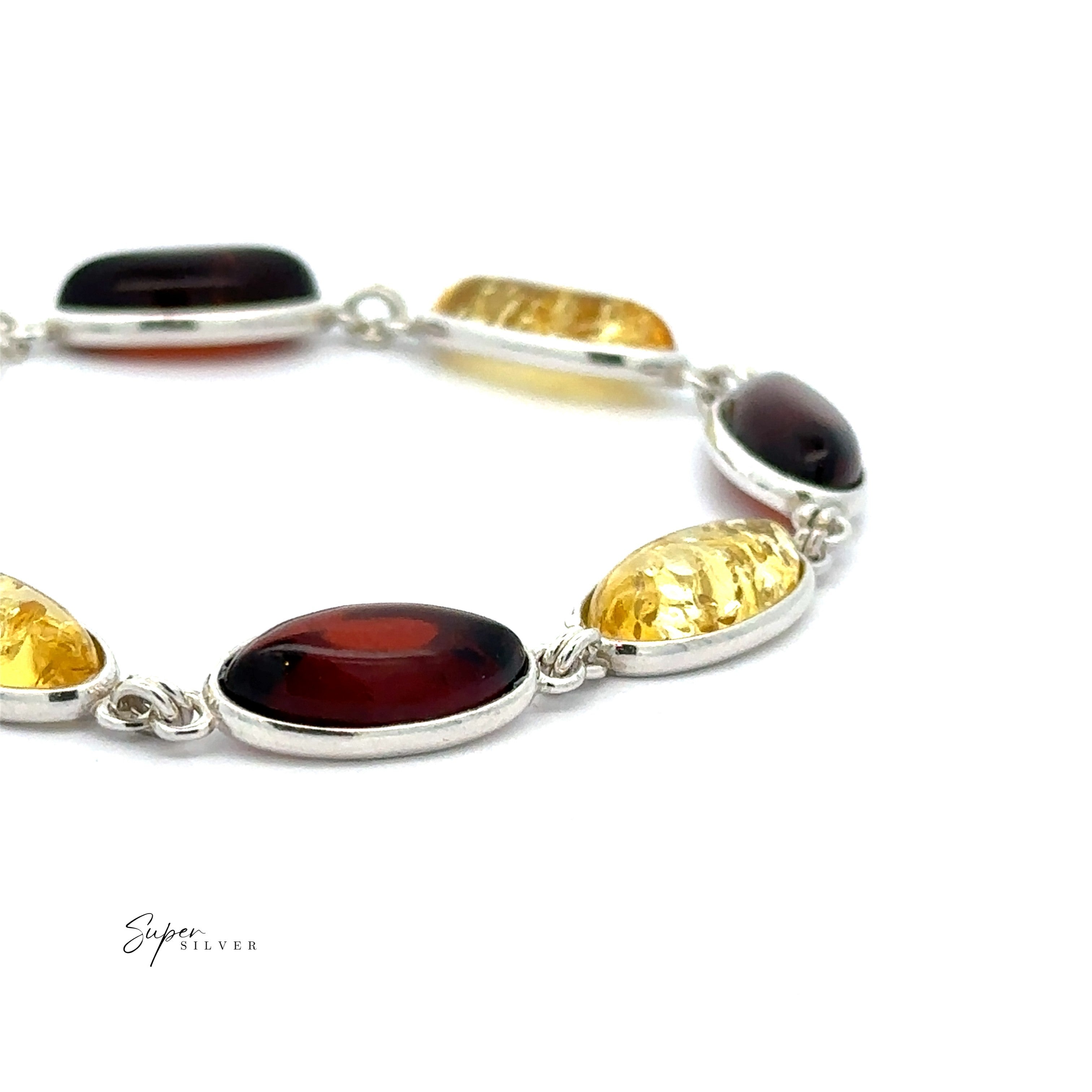 The Earthborn Amber Oval Bracelet features alternating dark red and yellow Baltic amber ovals set in sterling silver, shown on a white background—a perfect pick for boho jewelry lovers.