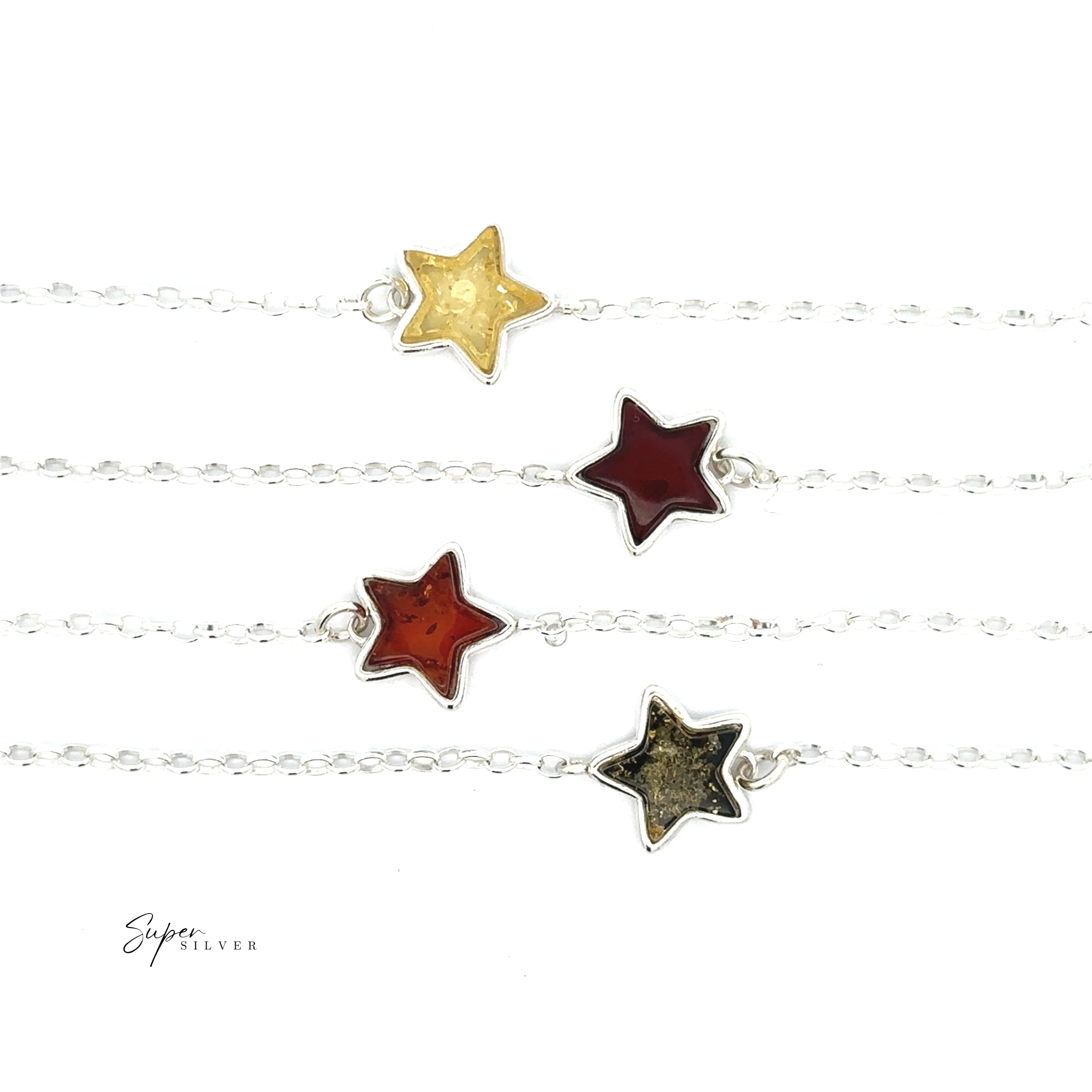 The Simple Amber Star Bracelet, featuring four amber-toned star pendants suspended from a minimalist sterling silver chain, is arranged horizontally on a white background.
