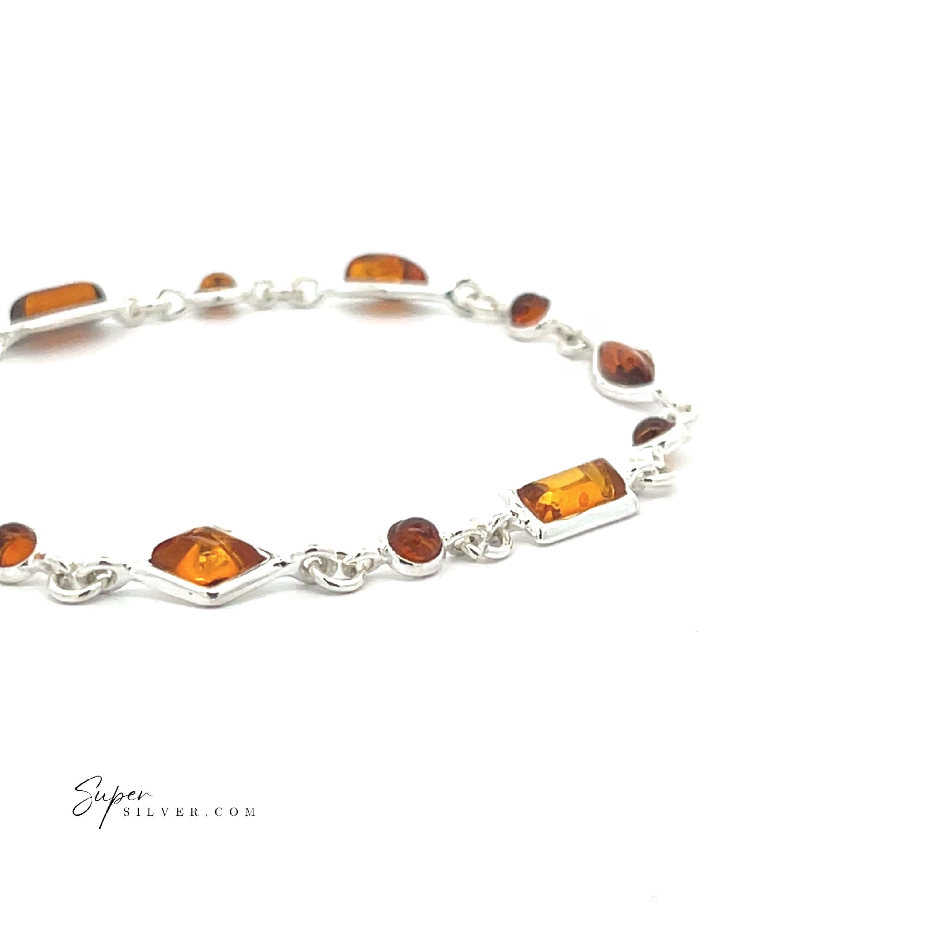 The Dainty Eclectic Baltic Amber Bracelet is a sterling silver piece featuring rectangular and round amber gemstones set in individual links, shown here on a white background.