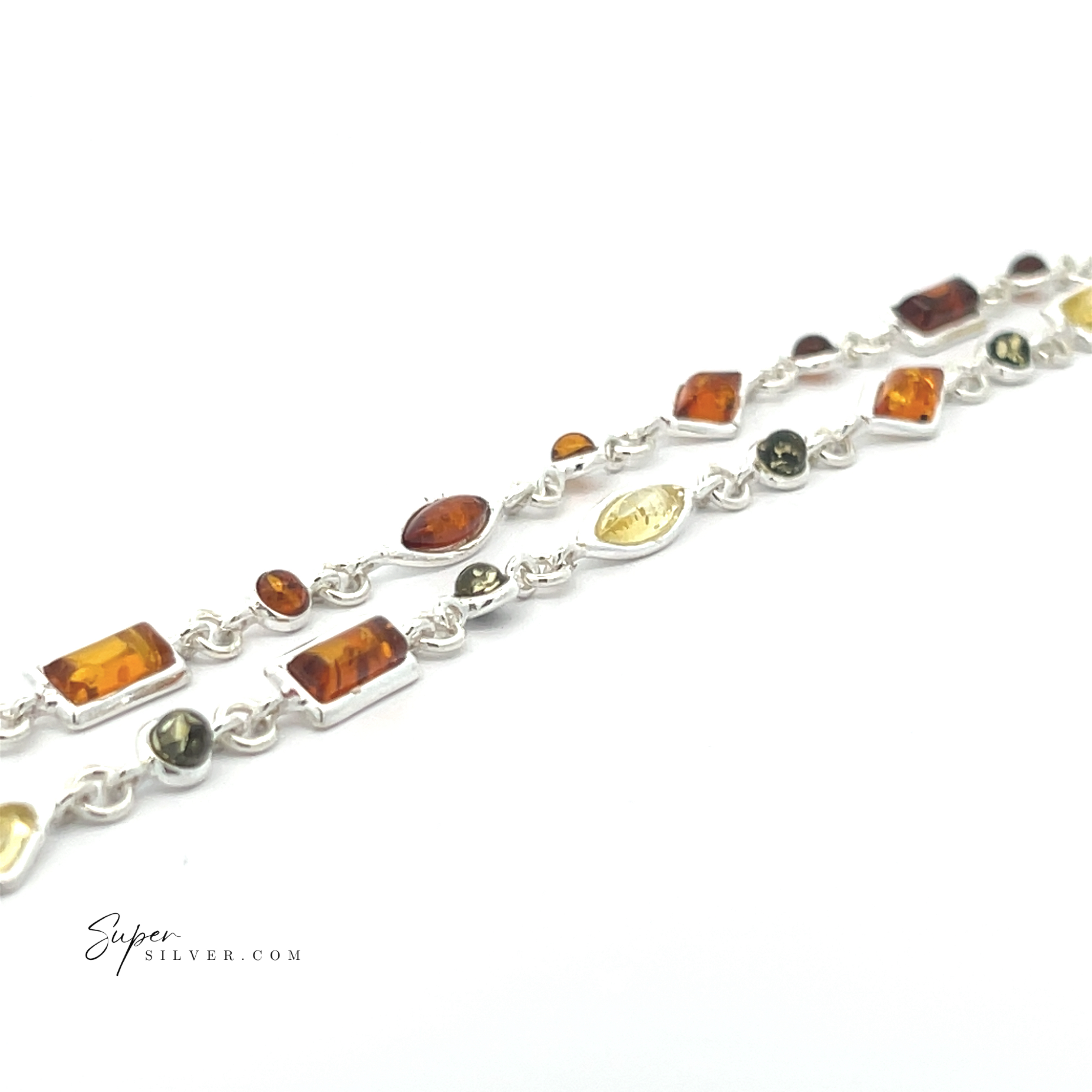 The Dainty Eclectic Baltic Amber Bracelet features uniquely shaped amber, green, and yellow stones set in sterling silver bezels—an eye-catching, one-of-a-kind jewelry piece displayed against a white background.