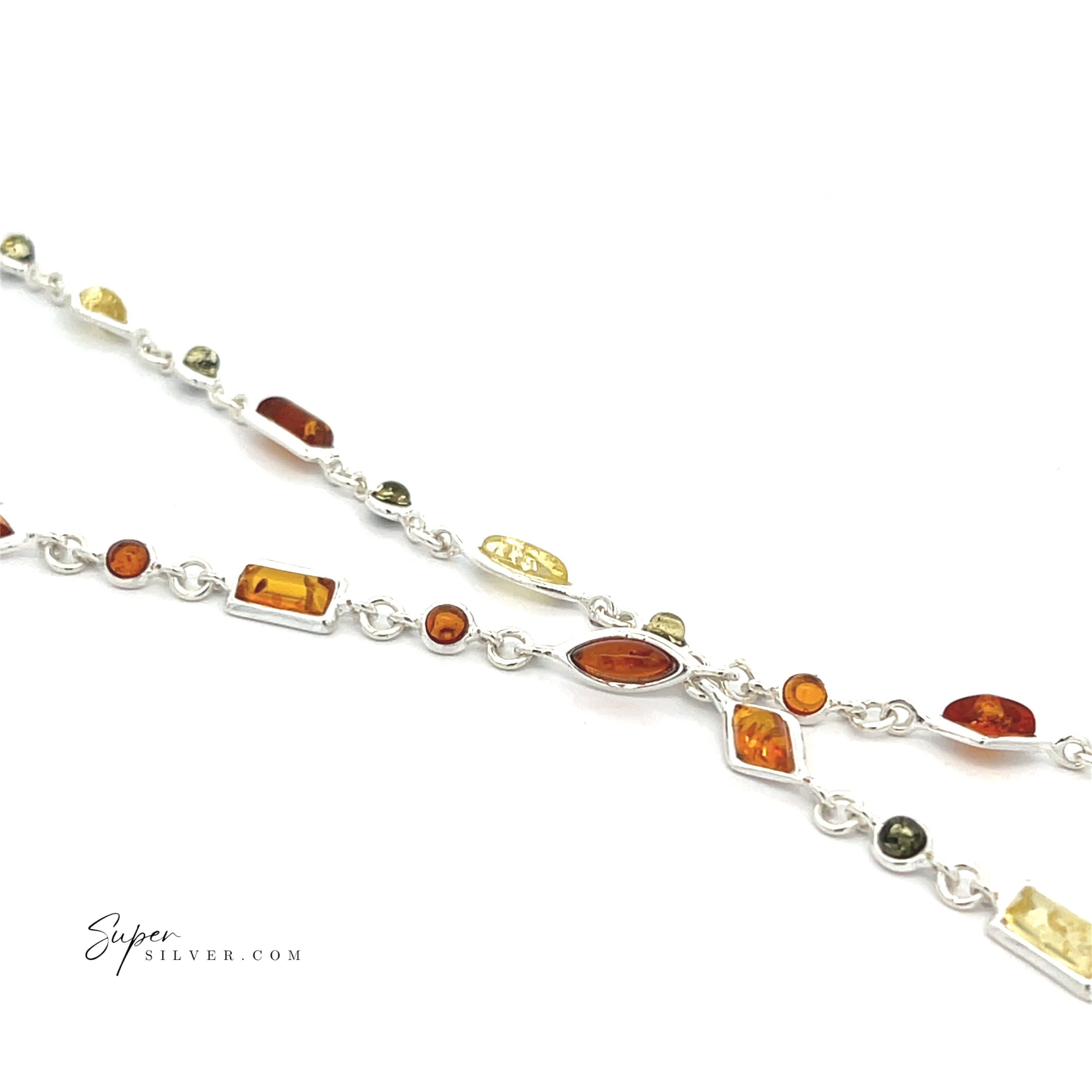 The Dainty Eclectic Baltic Amber Bracelet features sterling silver with Baltic amber and green gemstones in assorted shapes and sizes for a unique, eye-catching, and elegant look, shown on a white background.