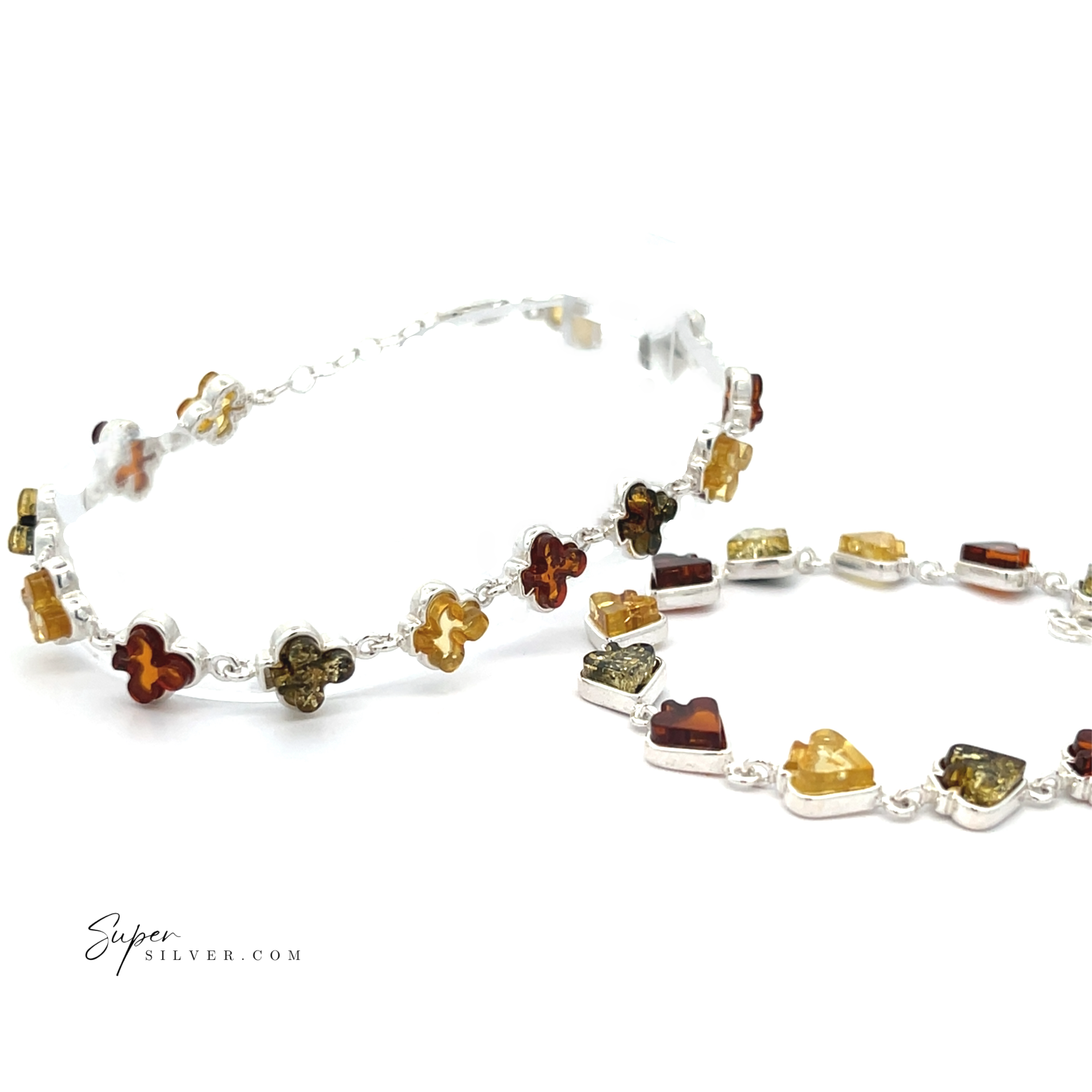 Two Amber Card Suit Bracelets, featuring clover-shaped yellow Baltic amber stones on sterling silver chains, are displayed on a white background. "SuperSilver.com" appears in the lower left corner.