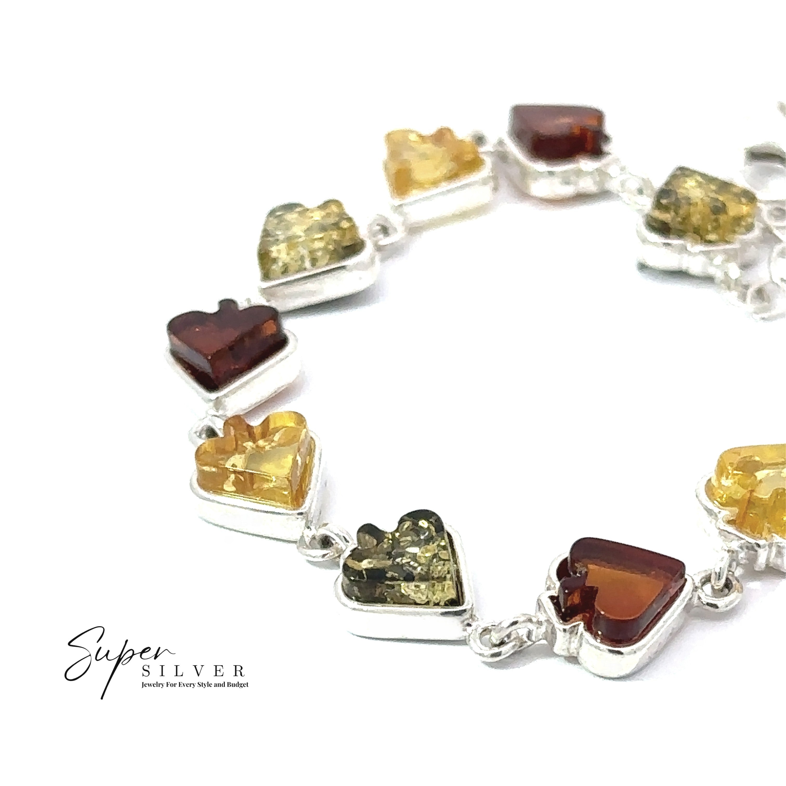 The Amber Card Suit Bracelet features alternating yellow and brown heart-shaped Baltic amber stones set in sterling silver links, shown on a white background with "Super Silver" branding.