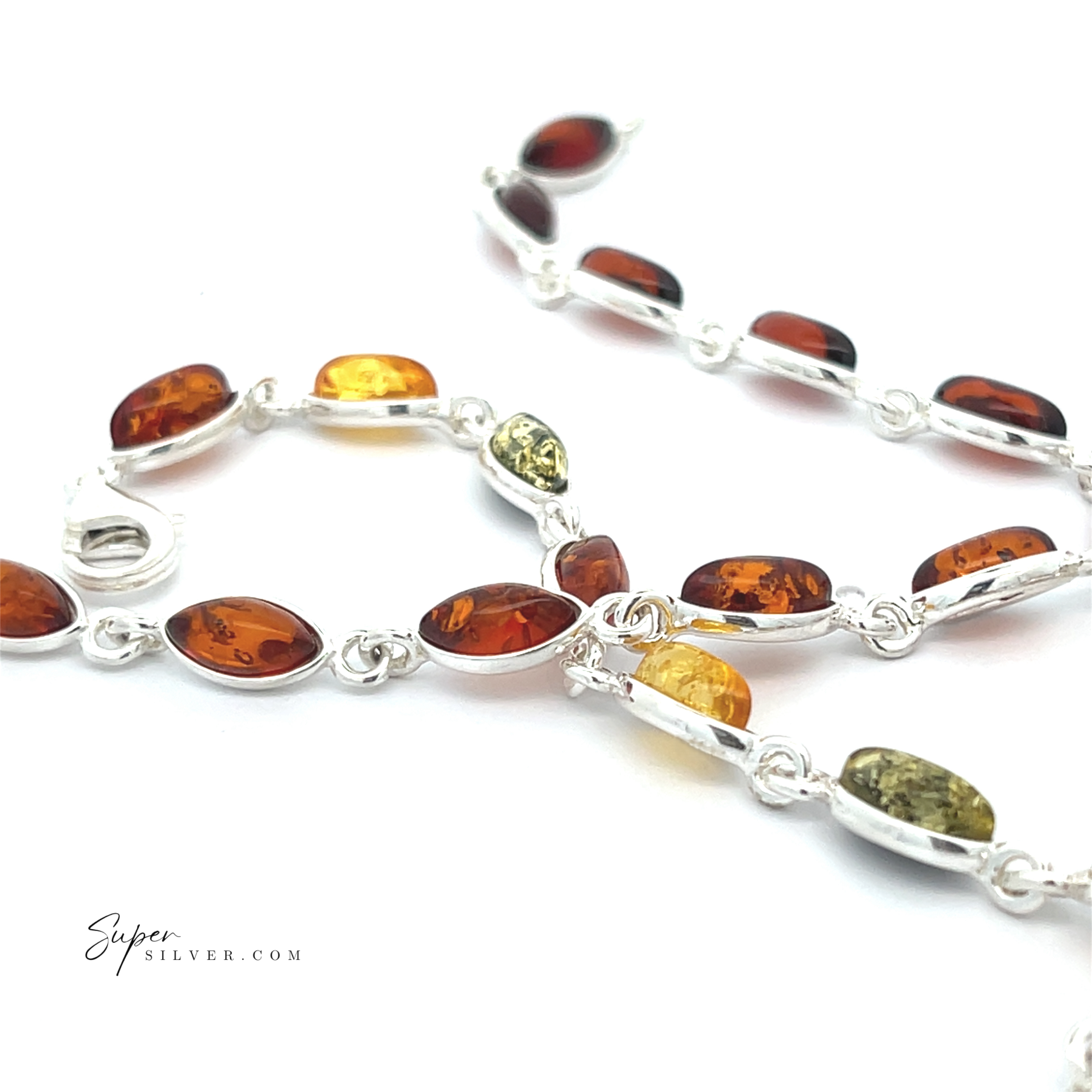 The Simple Marquise Baltic Amber Bracelet showcases marquise-shaped amber stones in brown, yellow, and green hues set in sterling silver on a white background, each gem reflecting a touch of ancient sunlight.
