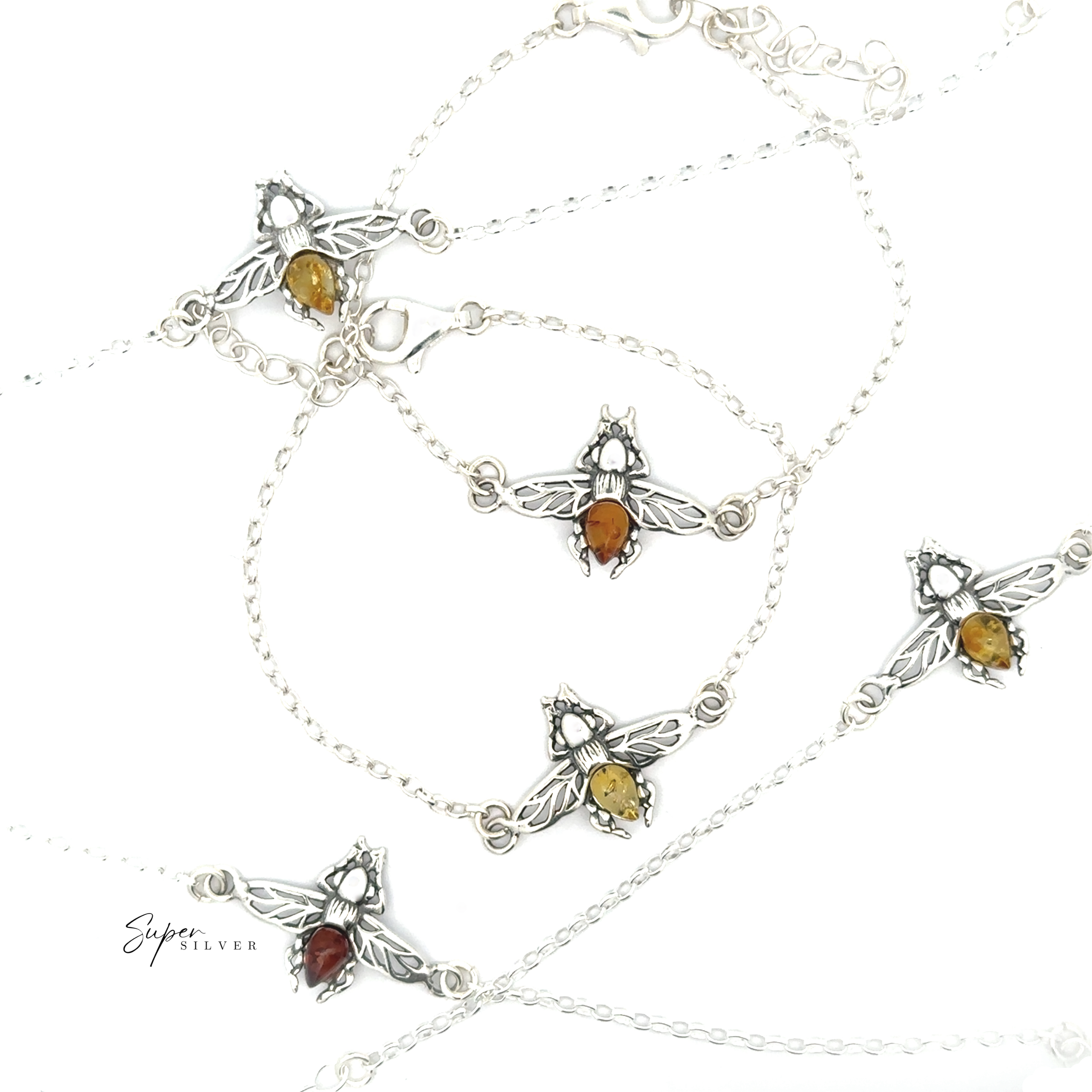 Five sterling silver bee necklaces with Baltic amber-colored stones are displayed on a white background. Each pendant's detailed wings and vibrant body pair perfectly with the Baltic Amber Bee Bracelet.