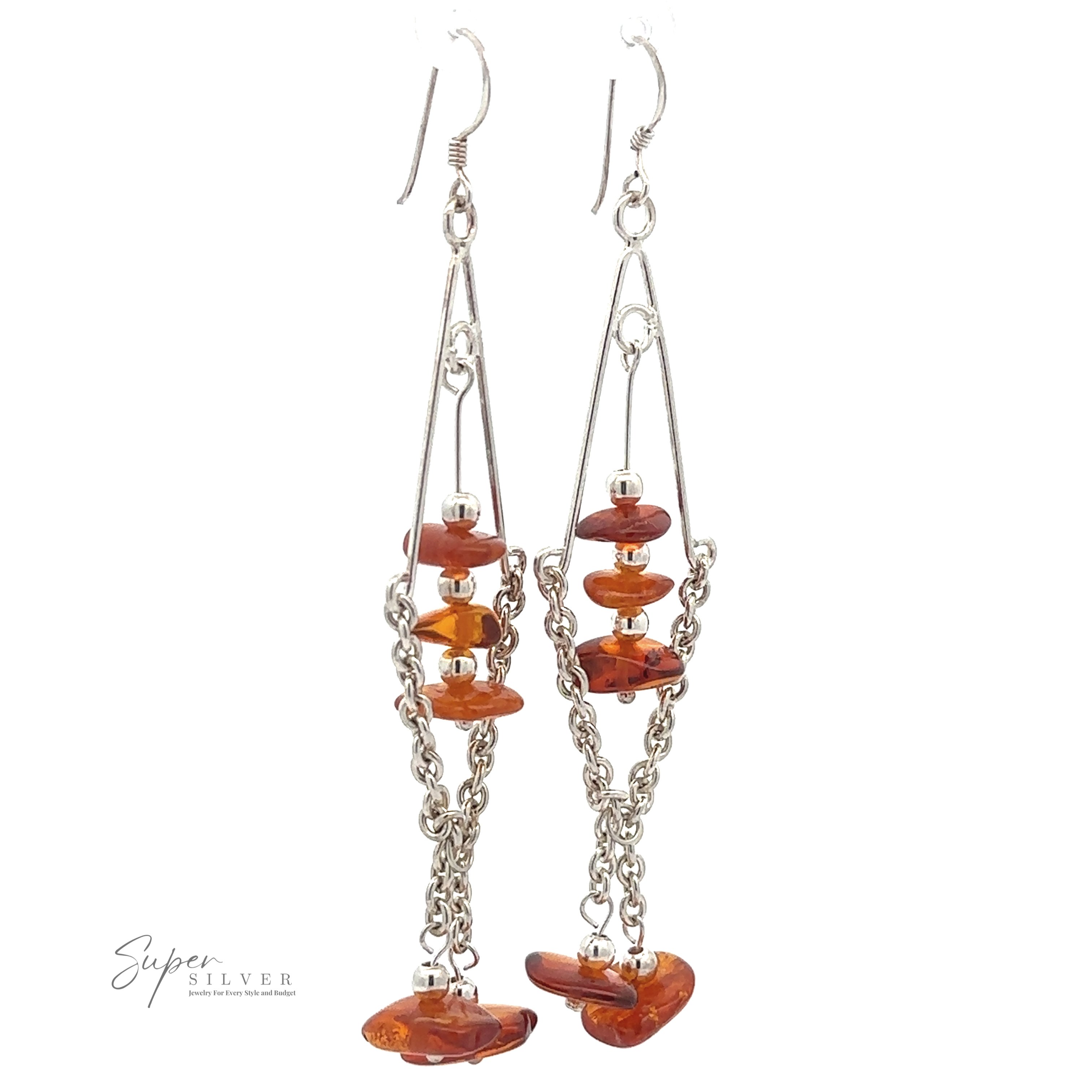 A pair of long, silver, wire-frame **Beaded Amber Tassel Earrings** featuring orange, irregularly shaped beads reminiscent of Baltic amber and hanging chain links in a beaded tassel design, set against a plain white background. Brand name "Super Silver" is visible.