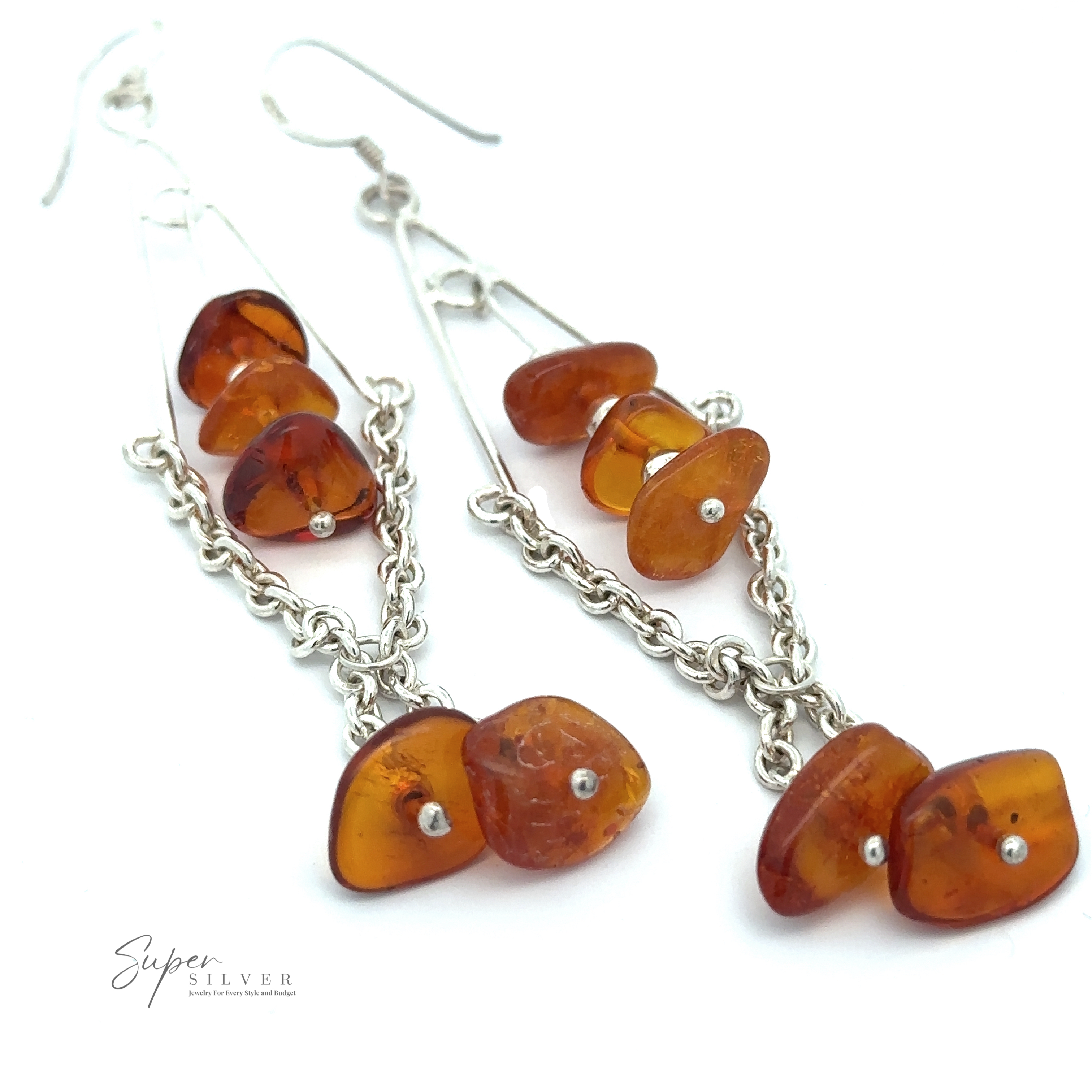 A pair of Beaded Amber Tassel Earrings featuring amber-colored stones and silver chains, observed against a white background with the Super Silver logo in the corner, perfect for festival fashion.