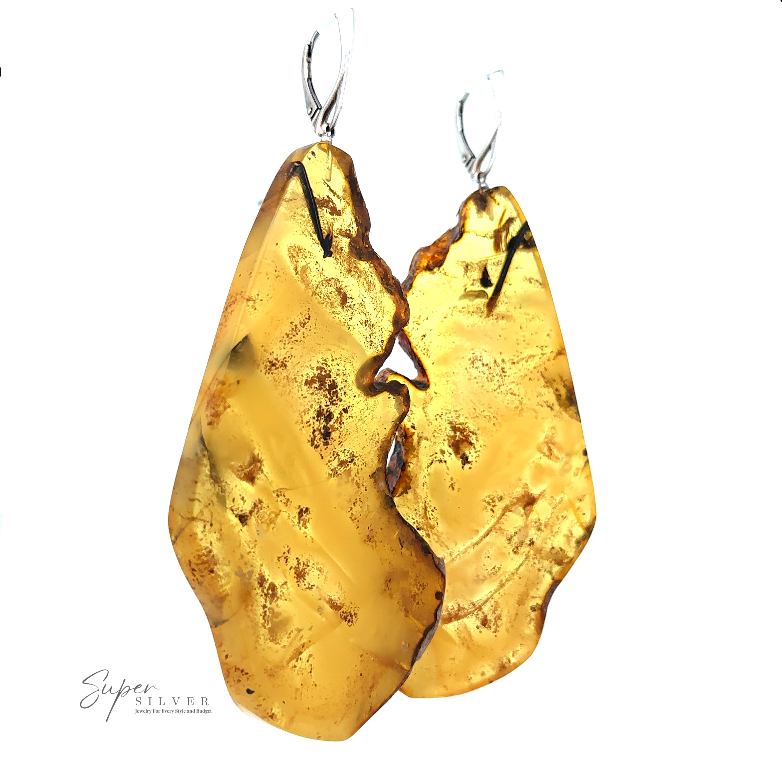 A pair of Designer Raw Cognac Amber Slab Earrings with silver hooks, featuring a rough and textured surface. The logo "Super Silver" is visible in the bottom left corner, highlighting these stunning handcrafted earrings.