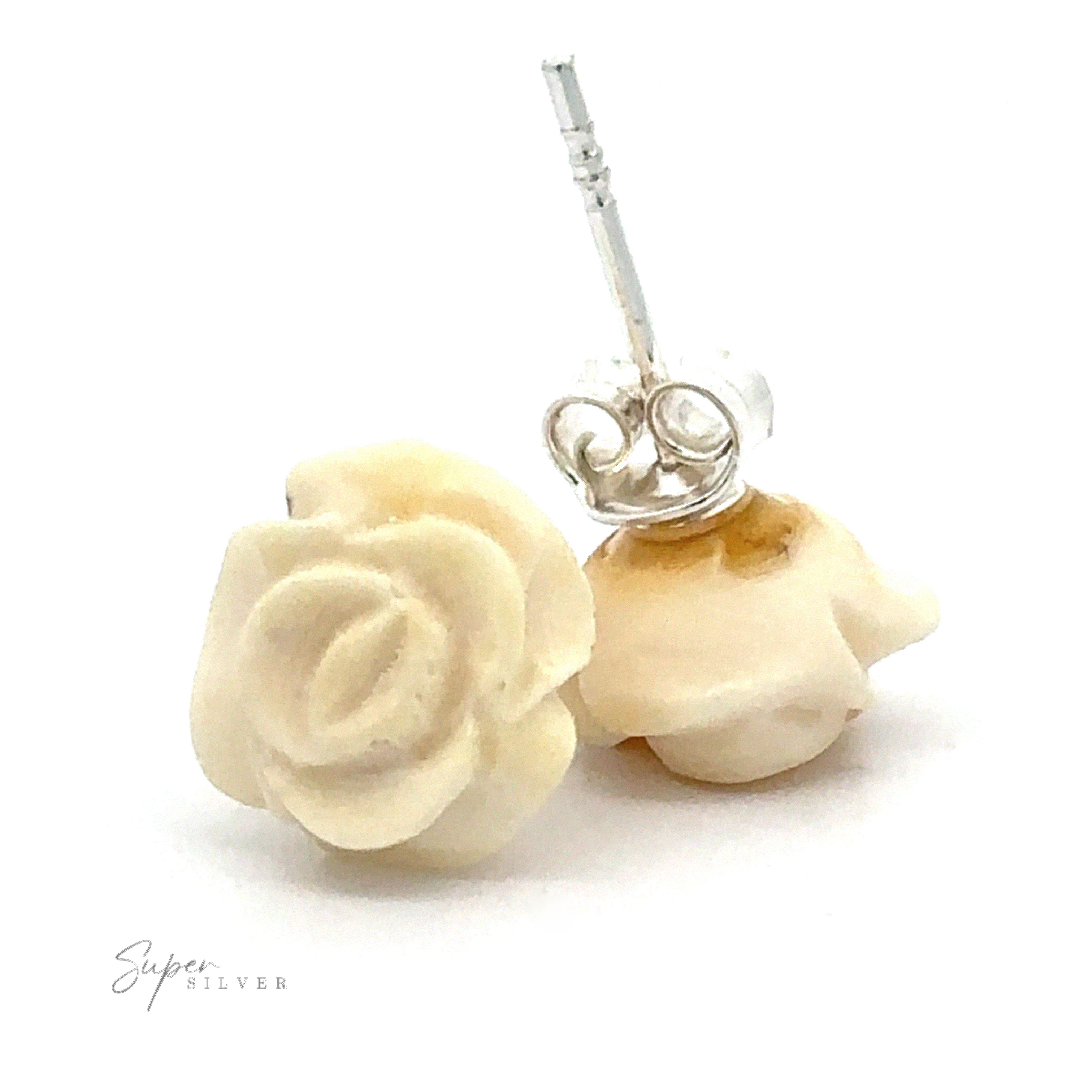 Close-up of a pair of intricately carved Butterscotch Amber Rose Studs with sterling silver backings, showcasing their creamy butterscotch hue against a pristine white background.