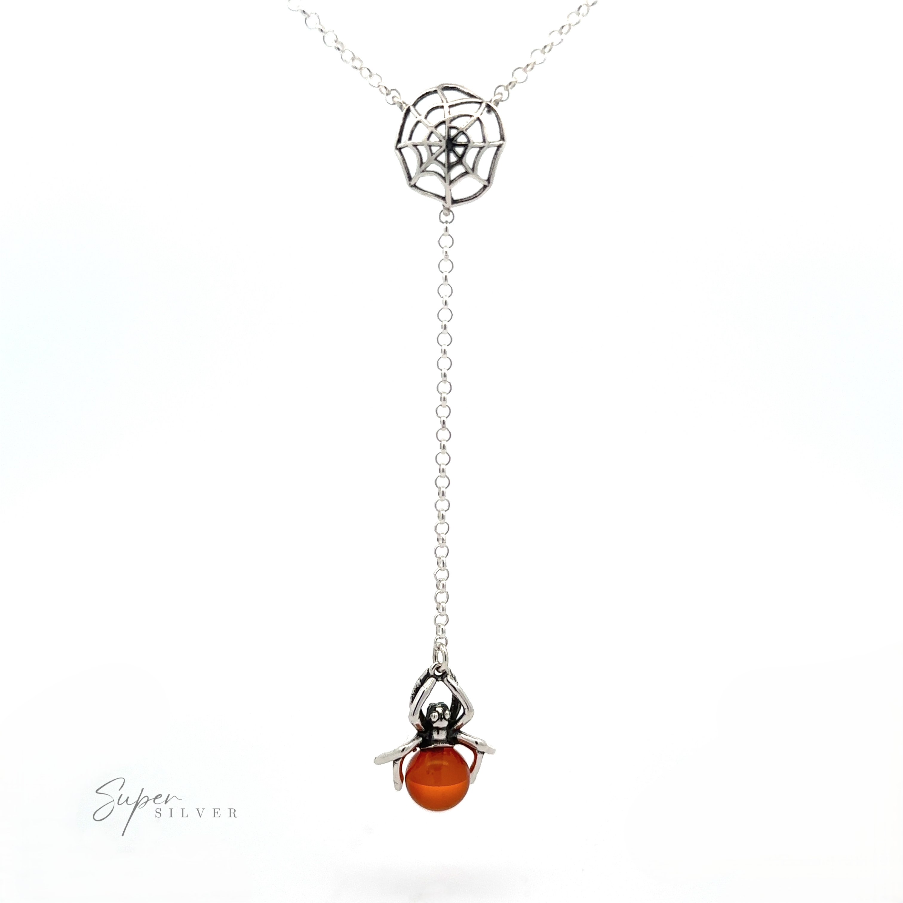 A Baltic Amber Spider Necklace with a spider and web pendant design, exuding a witchy vibe. The spider, suspended from the web by a chain, features a Baltic amber gemstone as its body. "Super Silver" is written in the bottom left corner.