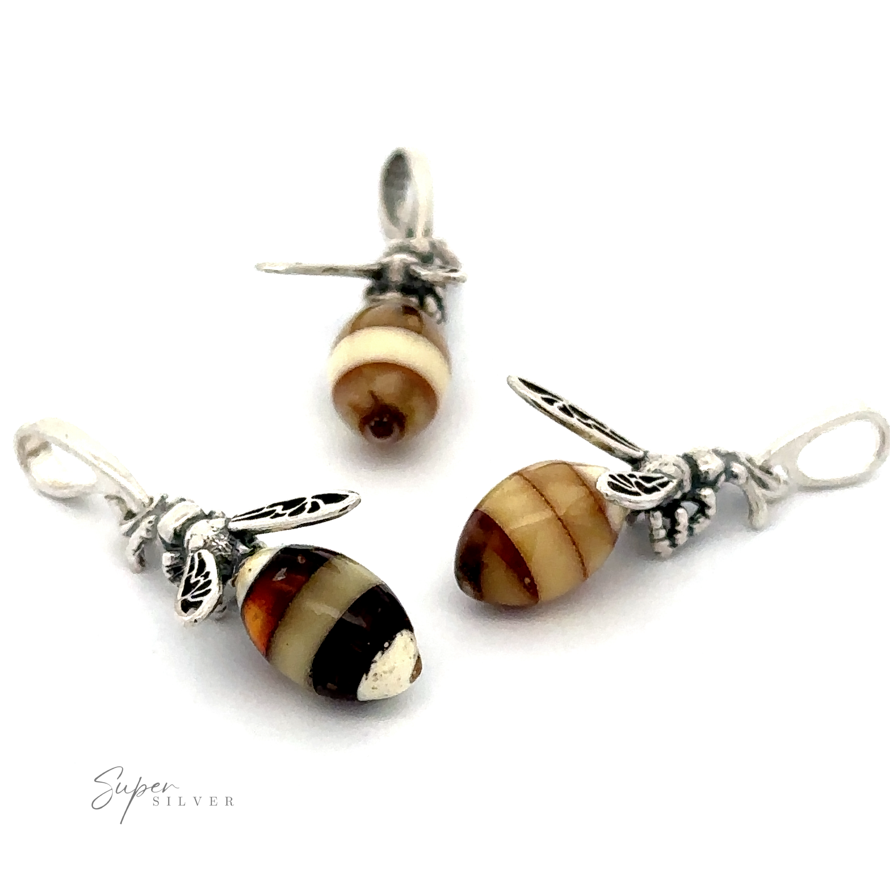 Three Beautiful Amber Yellow Jacket Pendants with brown and beige striped stone bodies are arranged on a white background. Text at the bottom left reads "Super Silver." These elegant pieces of sterling silver jewelry feature striking Baltic Amber bodies.