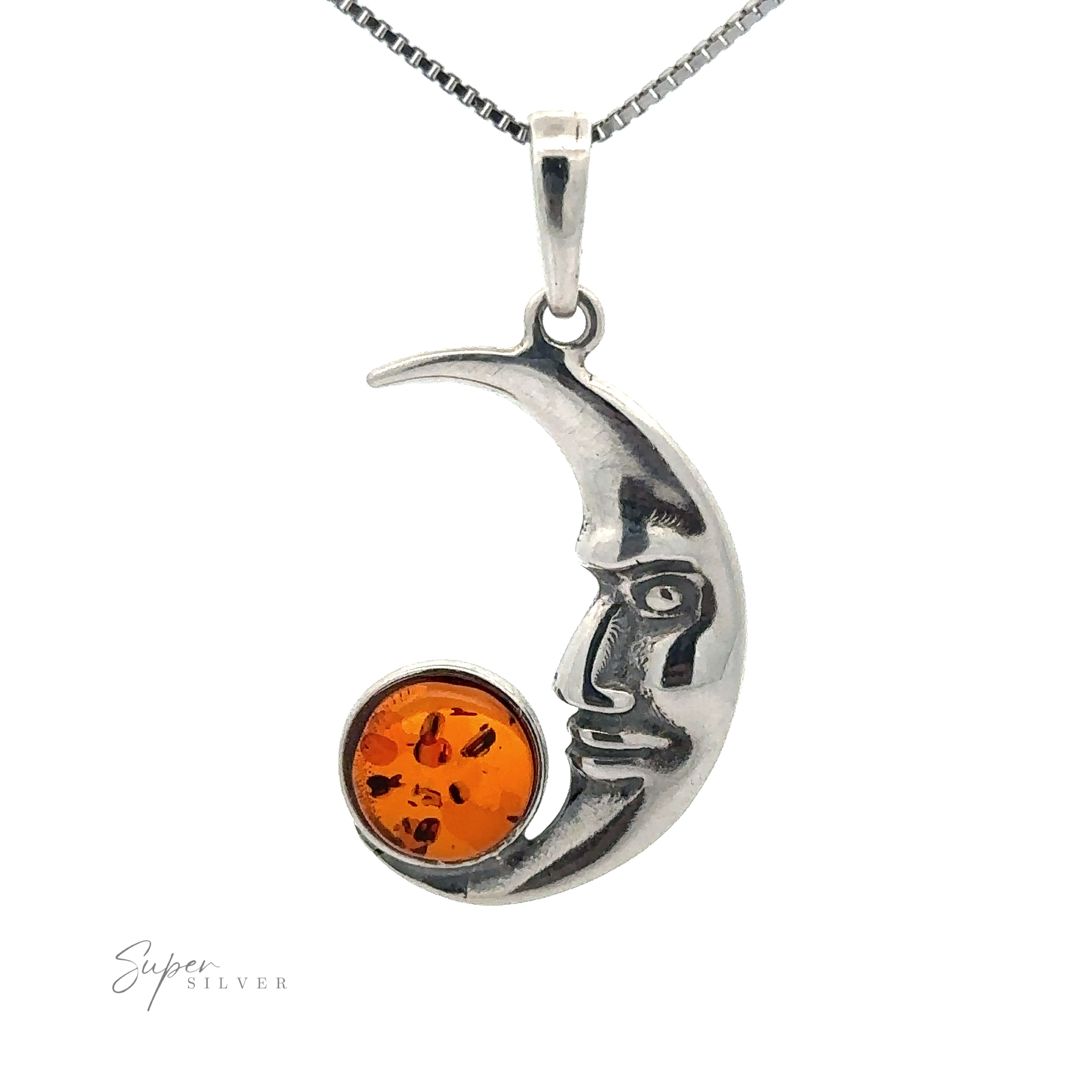 The Baltic Amber Man in the Moon Pendant features a human face design, holding a circular Baltic Amber gem. The pendant is suspended on a silver chain against a white background.