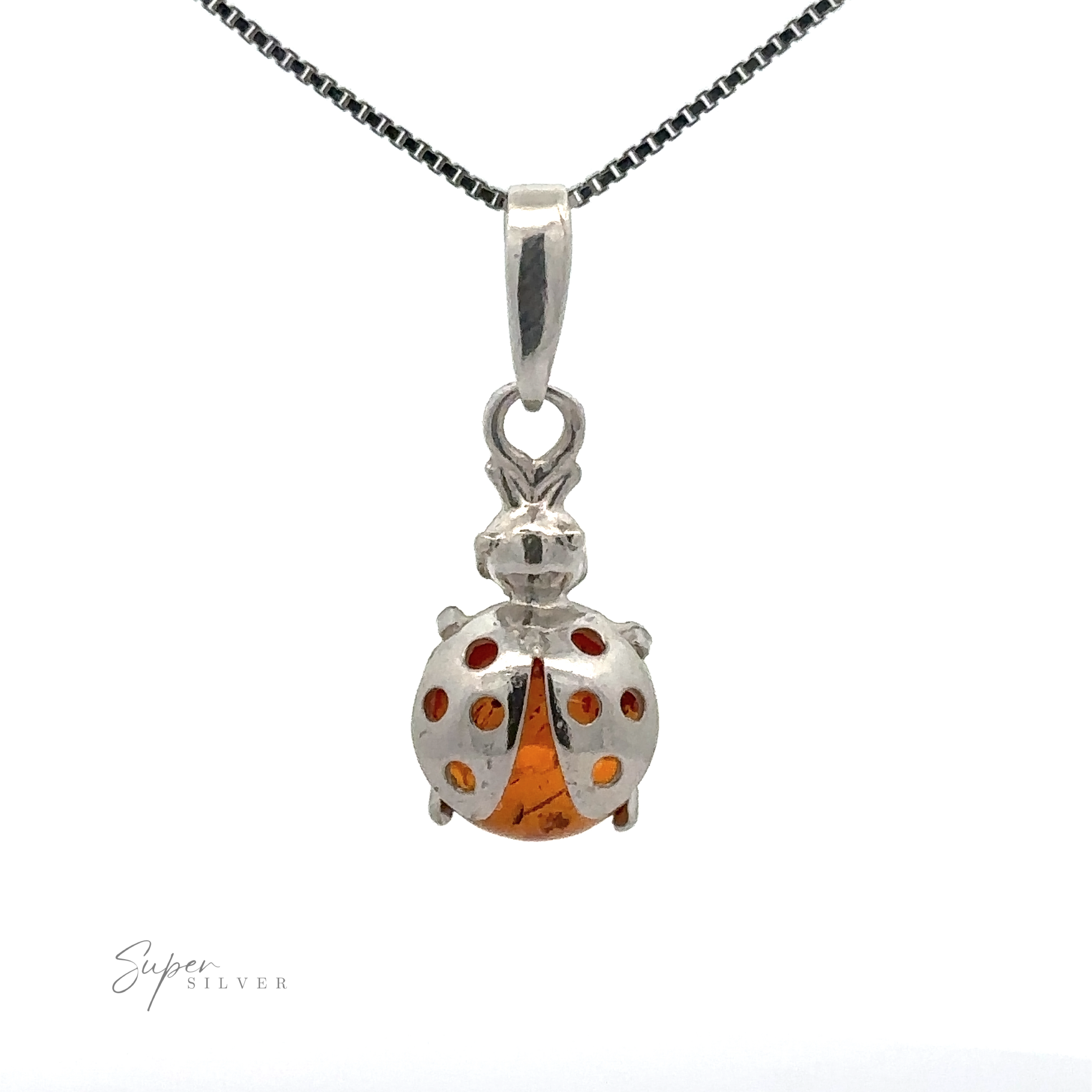 A sterling silver **Amber Ladybug Pendant** hangs on a silver chain. The background is white. The text "Super Silver" is visible at the bottom left.