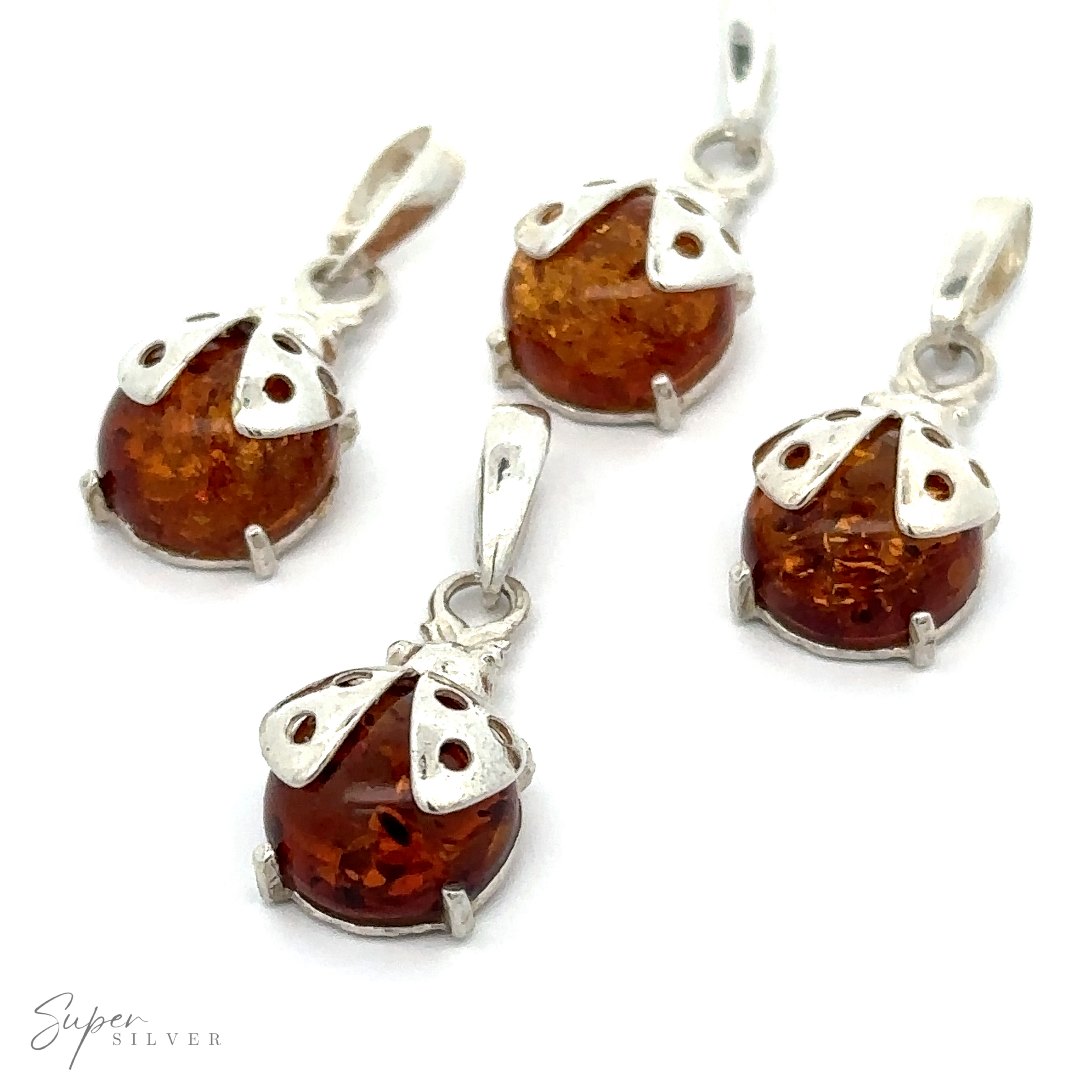 Four Amber Ladybug Pendants are arranged on a white background.