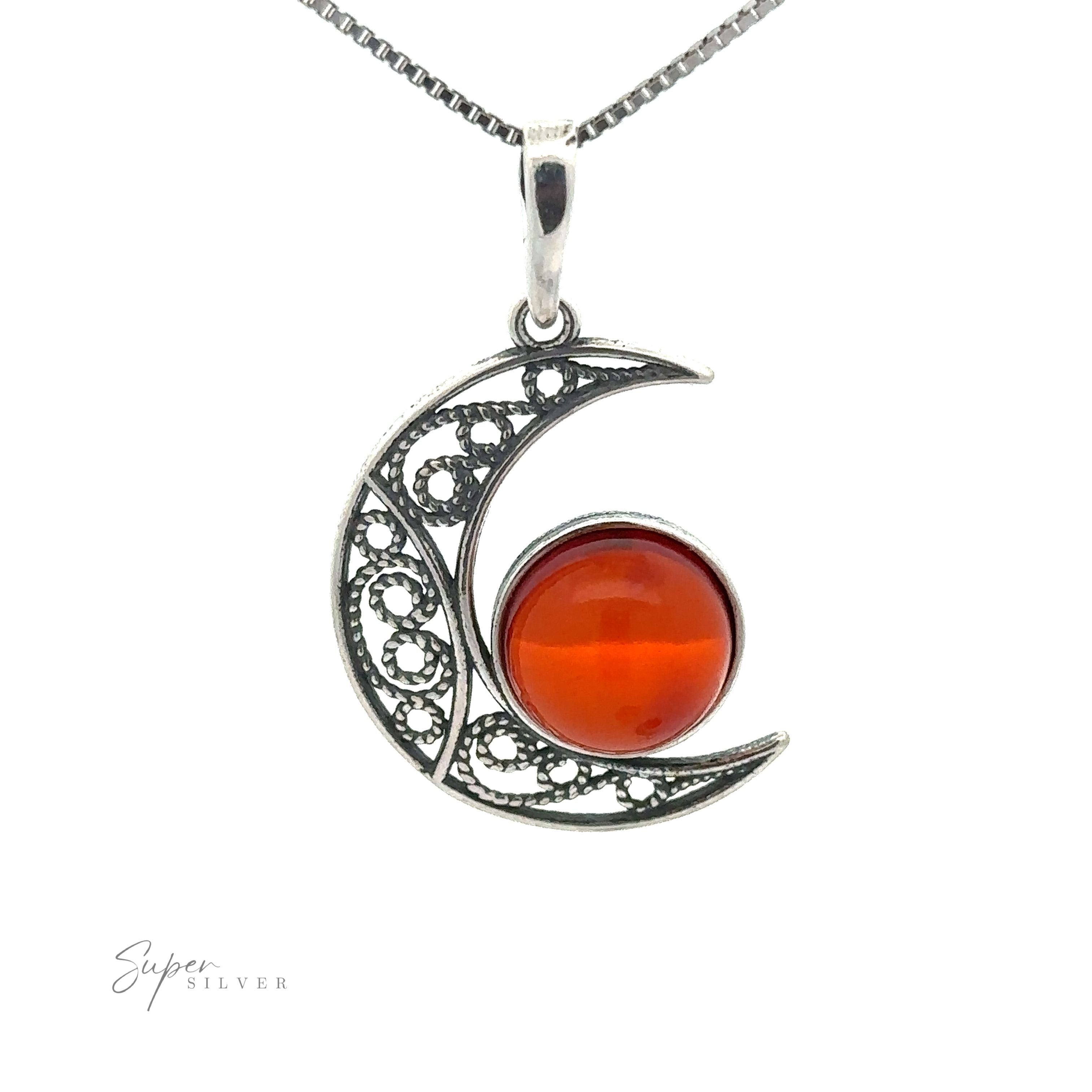 A Baltic Amber Moon Pendant features a crescent moon shape with an intricate design and a red gemstone in the center. Branding text "Super Silver" is visible in the lower left corner, adding to the charm of this exquisite piece.