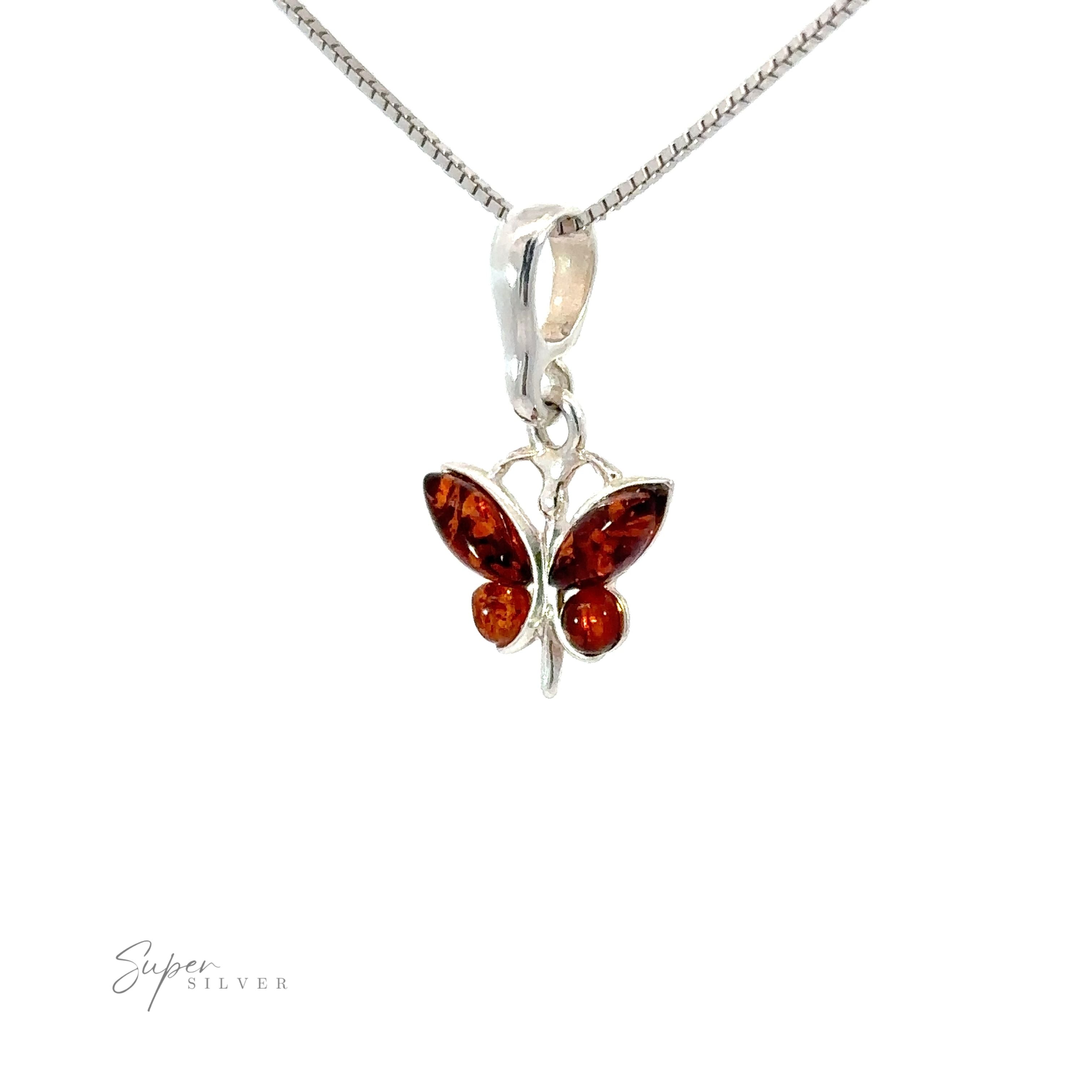 Small Amber Butterfly Pendants, nature-inspired Baltic amber pendants in sterling silver, shaped like butterflies.