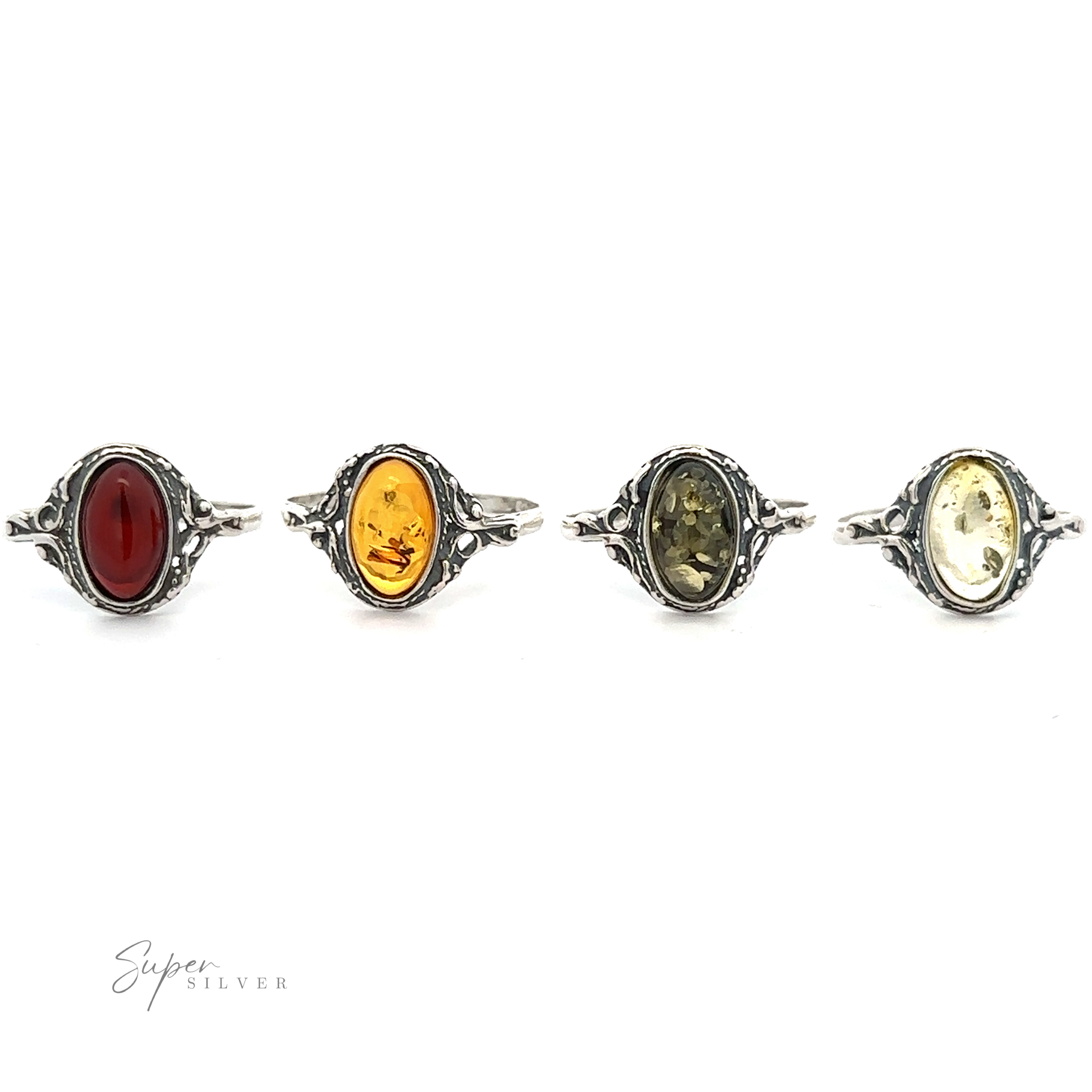 Four Delicate Baltic Amber Rings with Antique Settings, displayed in a row against a white background.