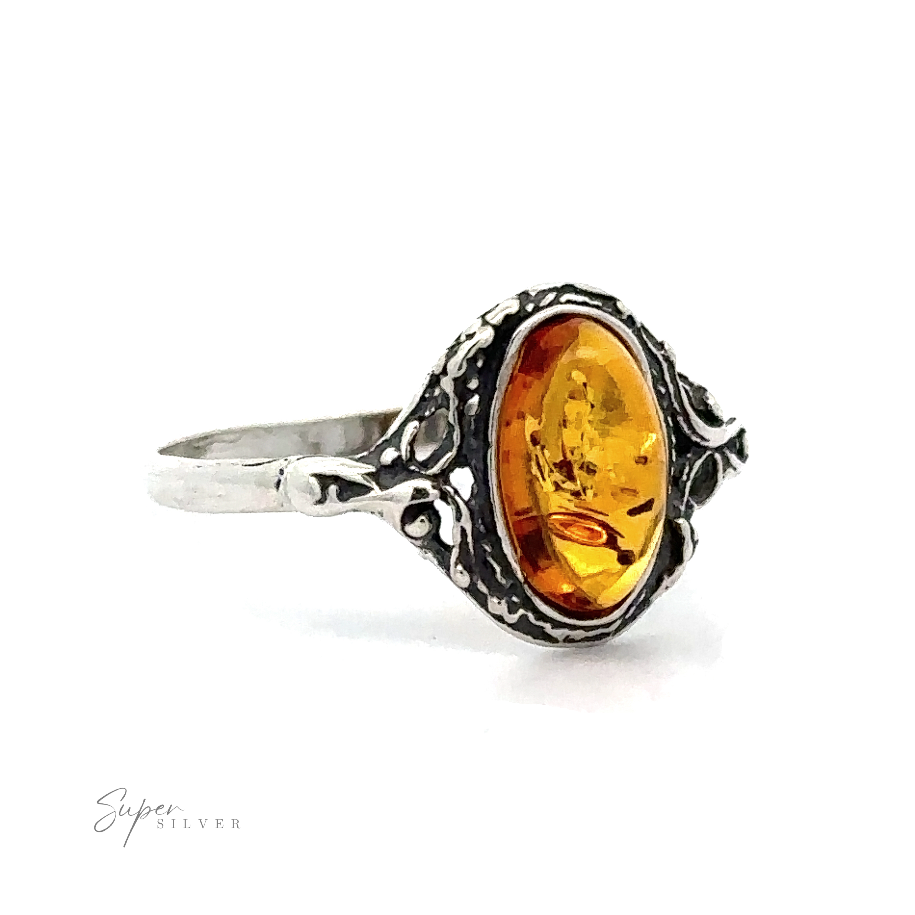 Delicate Baltic Amber Ring with Antique Setting featuring an oval-shaped cognac amber stone set in an intricately designed band, displayed against a white background.