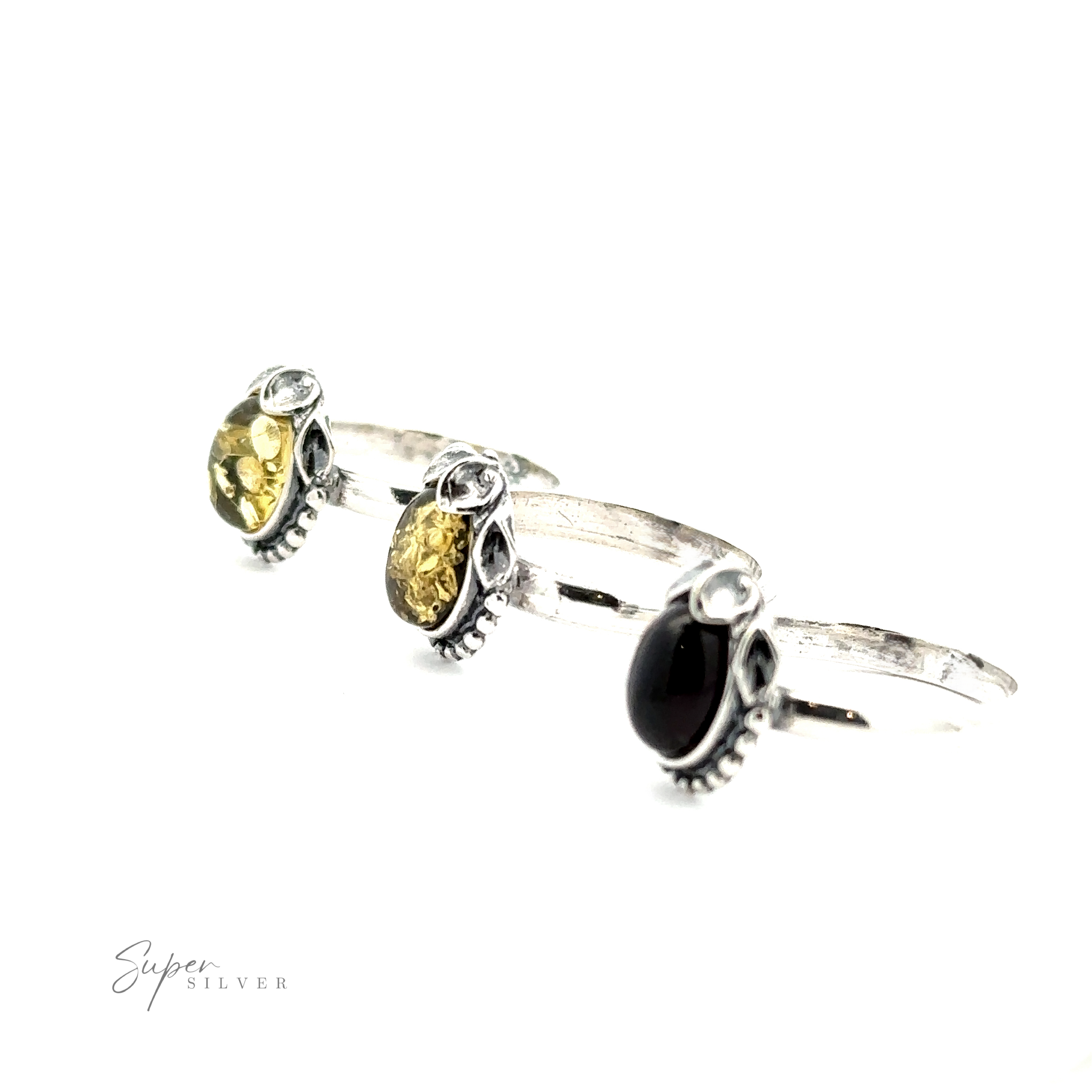 Three Amber Rings with Beaded Border and Peace Lily Details, two with yellow gemstones and one with a black gemstone, arranged in a row against a white background. The image has a "Super Silver" watermark in the lower left corner, showcasing the vintage elegance of these nature-inspired pieces.