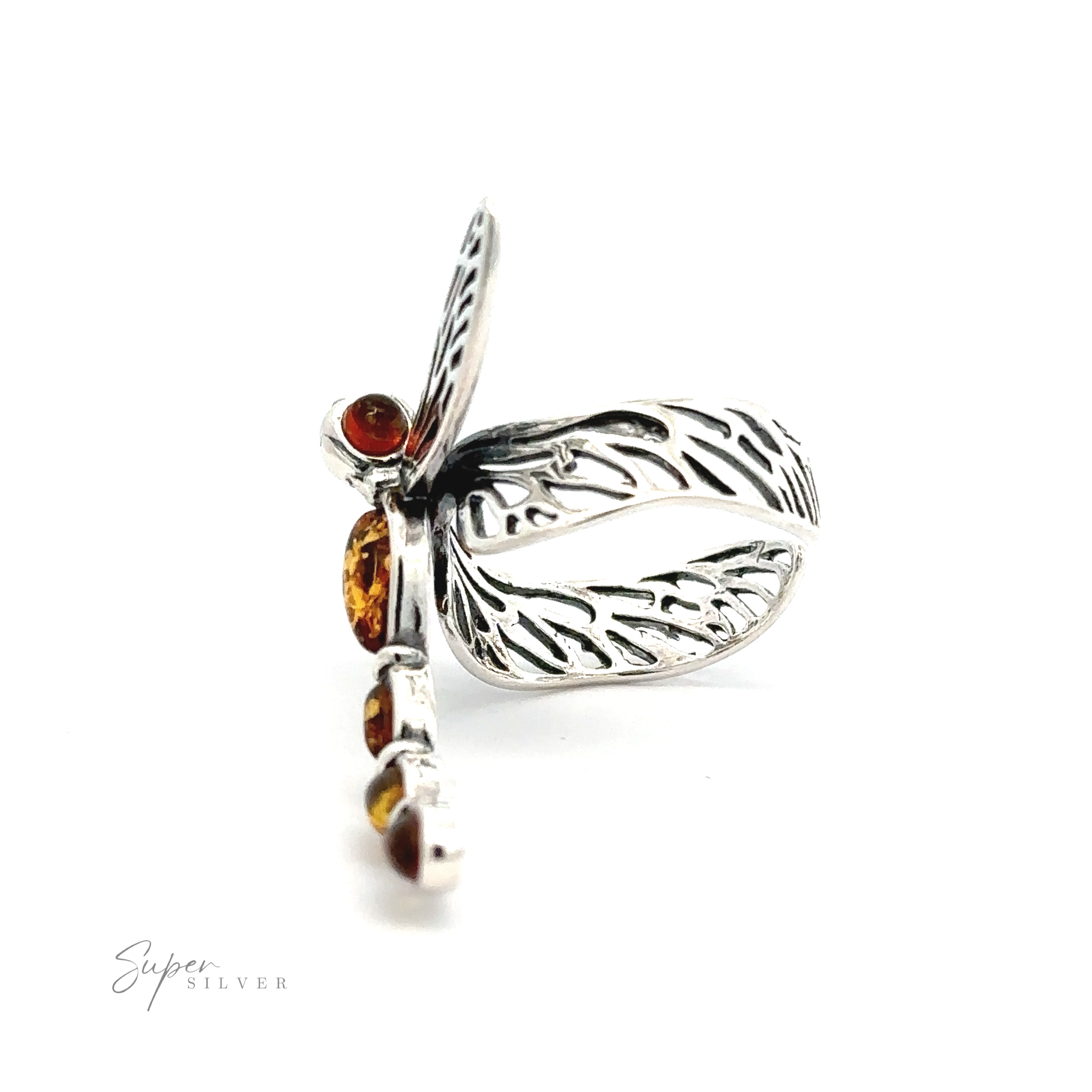 A silver, intricately detailed Amber Dragonfly Adjustable Ring with cognac amber stones embedded on the body and wings, displayed against a plain white background. This piece of nature-inspired jewelry exudes elegance and charm.