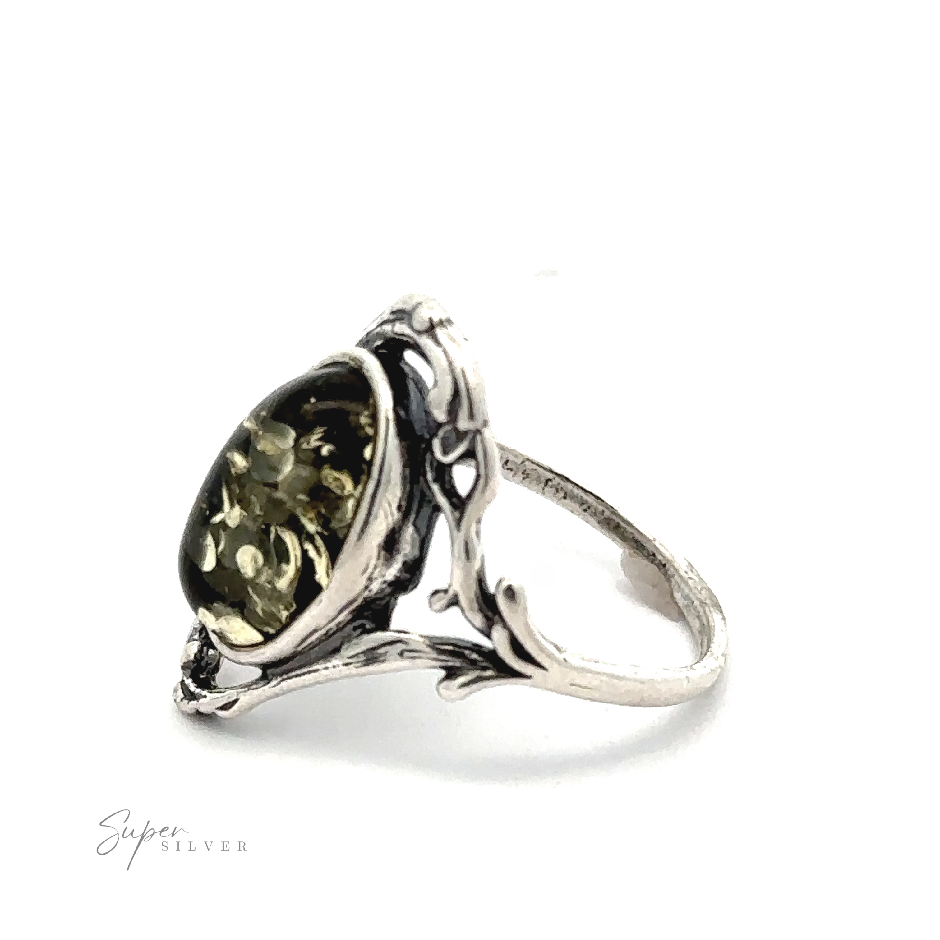 A silver ring with an intricately designed band holds a large, round green gemstone, exuding Antique Allure. The brand name "Amber Ring with Vine Detailing" appears in the bottom left corner.