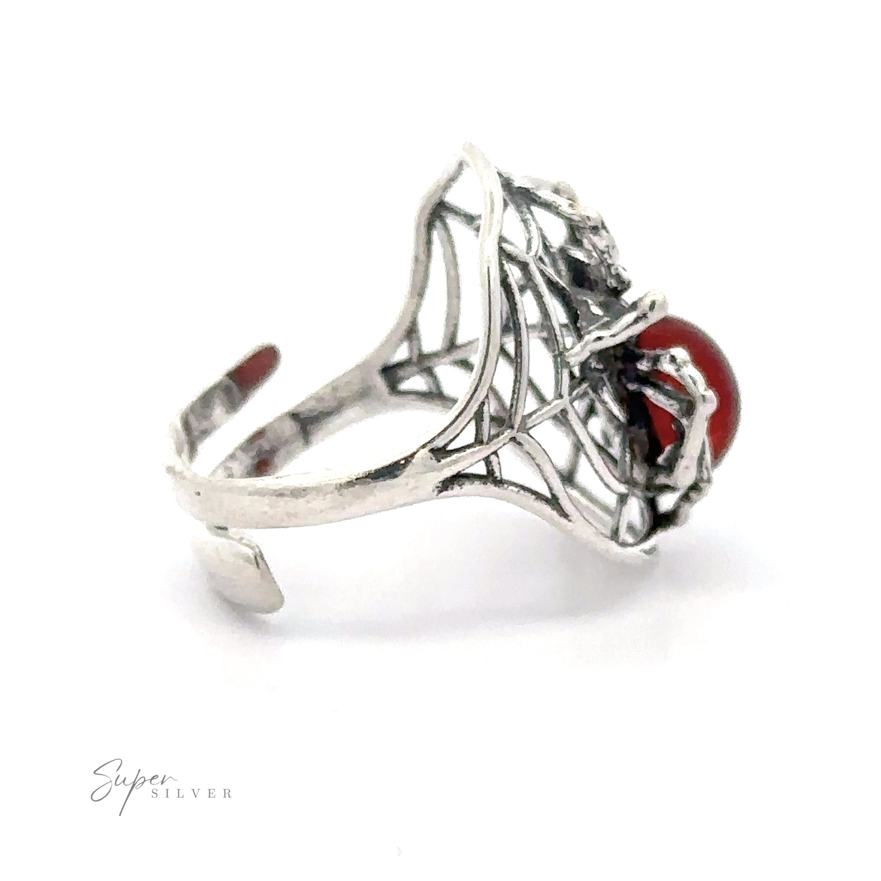 A silver filigree ring featuring an intricate design with an Entrancing Adjustable Baltic Amber Spider Ring encapsulated at one end.