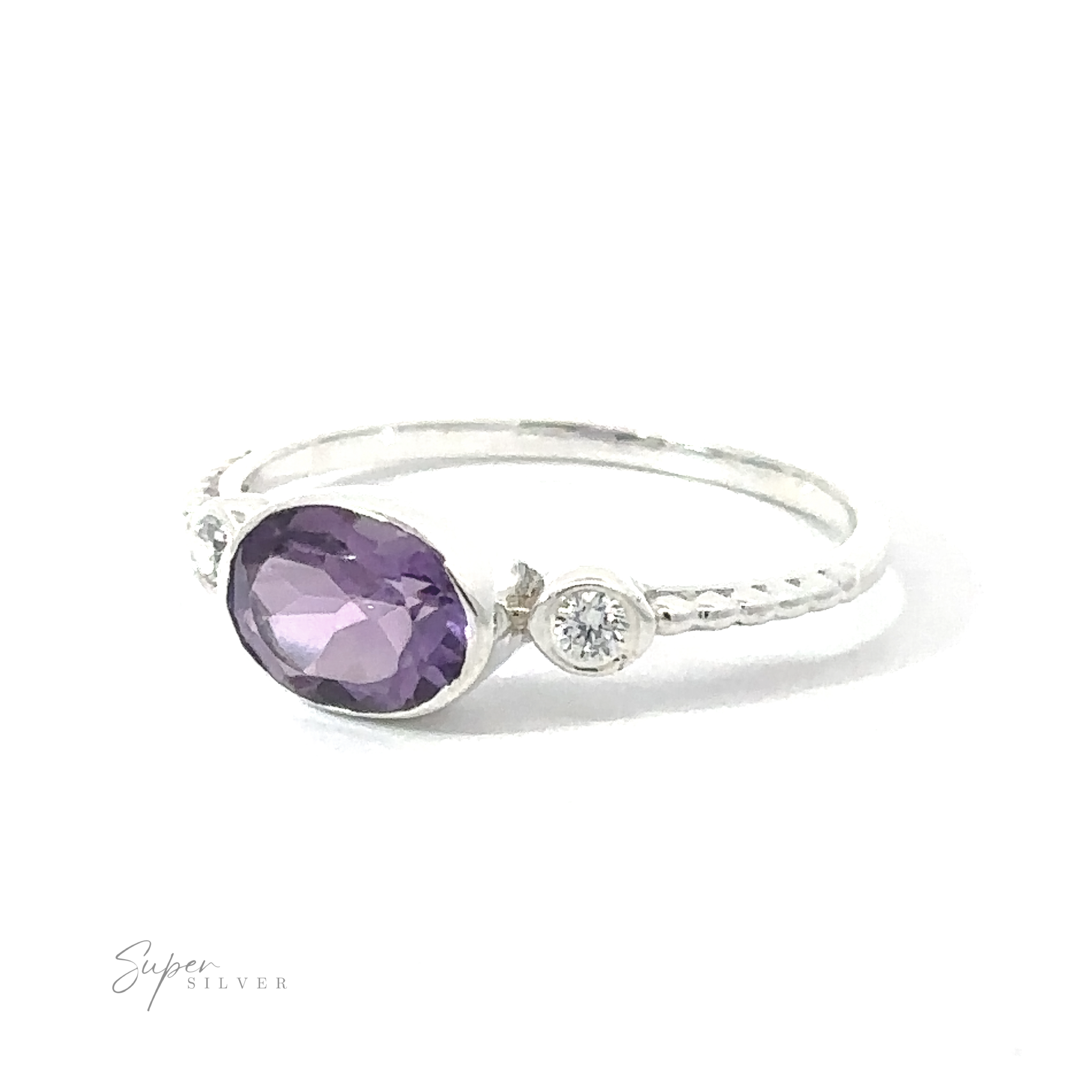 Horizontal Oval Gemstone Ring with Beaded Band with a small round diamond, set against a white background.