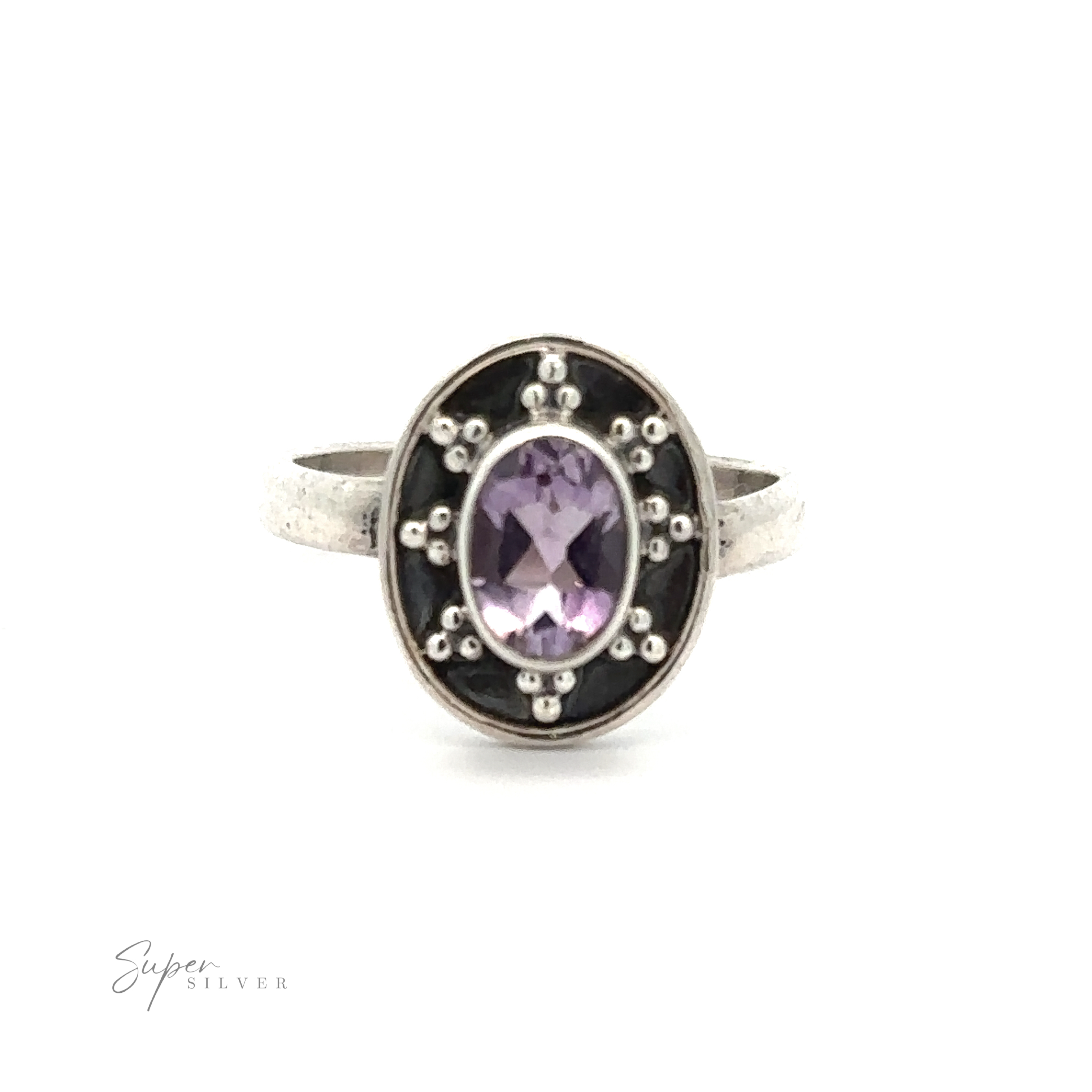 An Oval Gemstone Ring with Ball and Disk Border featuring an oval-shaped purple gemstone set in the center, surrounded by small silver bead details. This vintage-inspired jewelry piece stands out beautifully against the plain white background.