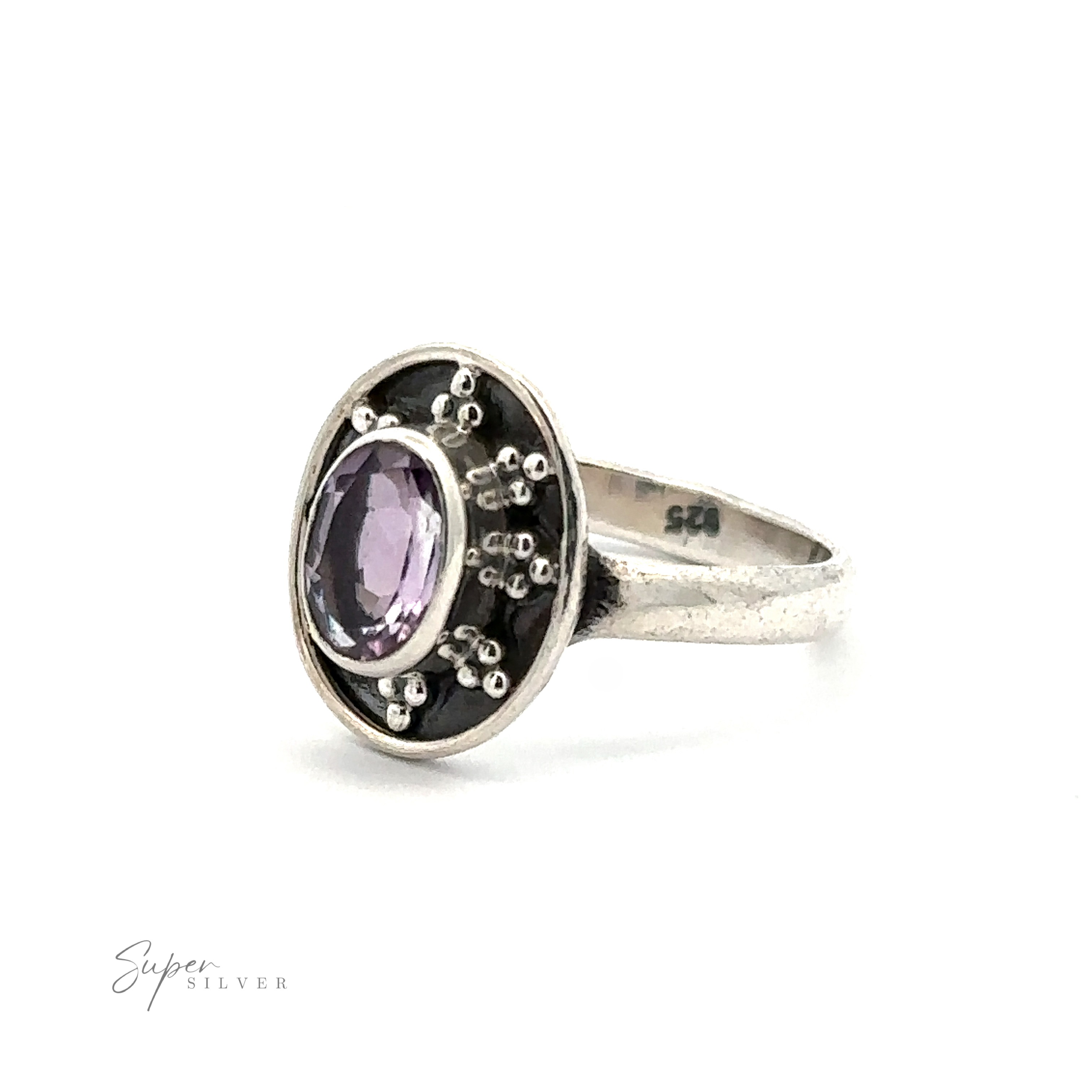 Oval Gemstone Ring with Ball and Disk Border with an oval-shaped purple gemstone and intricate metalwork, displayed against a white background. "Super Silver" is visible in the bottom left corner, giving this vintage-inspired jewelry piece an elegant touch.