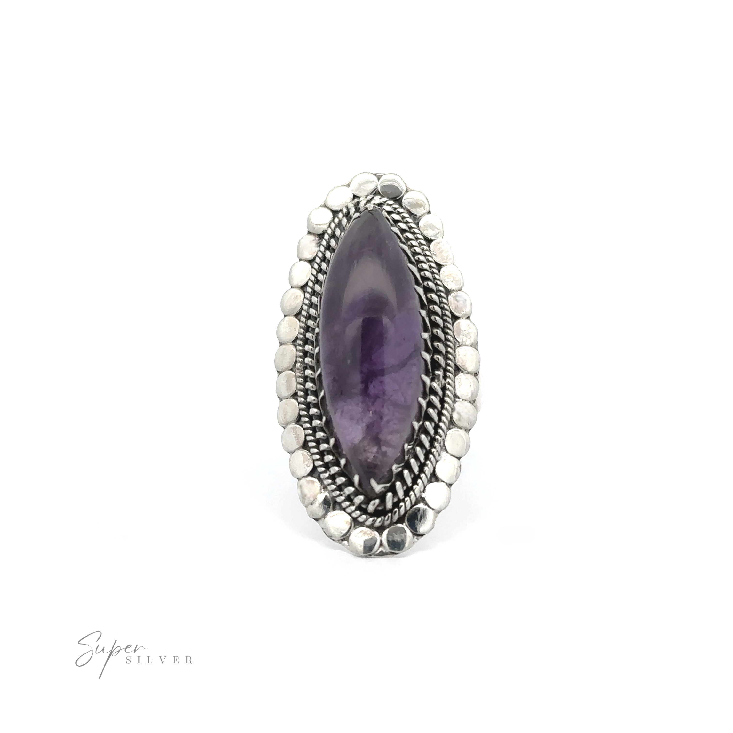 An oval-shaped purple gemstone set in a decorated silver ring. The ring features detailed silverwork with a pattern of small silver dots surrounding the large gemstone, embodying the spirit of Bohemian jewelry. Text reads "Statement Marquise Shaped Gemstone Ring.