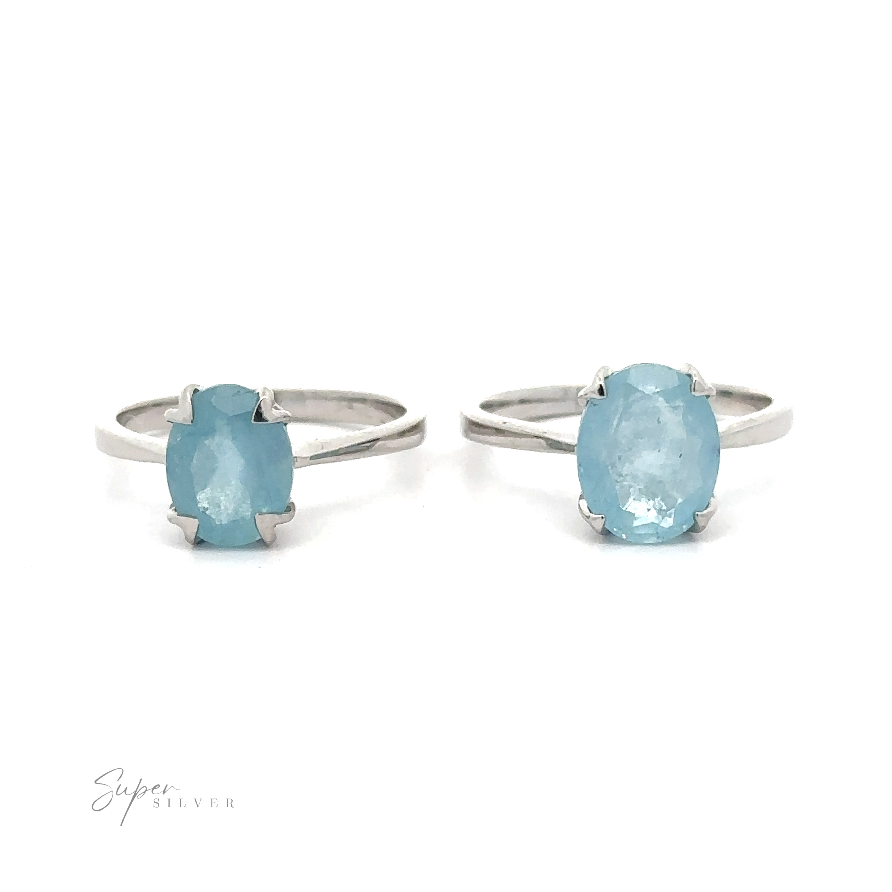Two Aquamarine Rings, each with a large oval aquamarine gemstone, set on a white background.