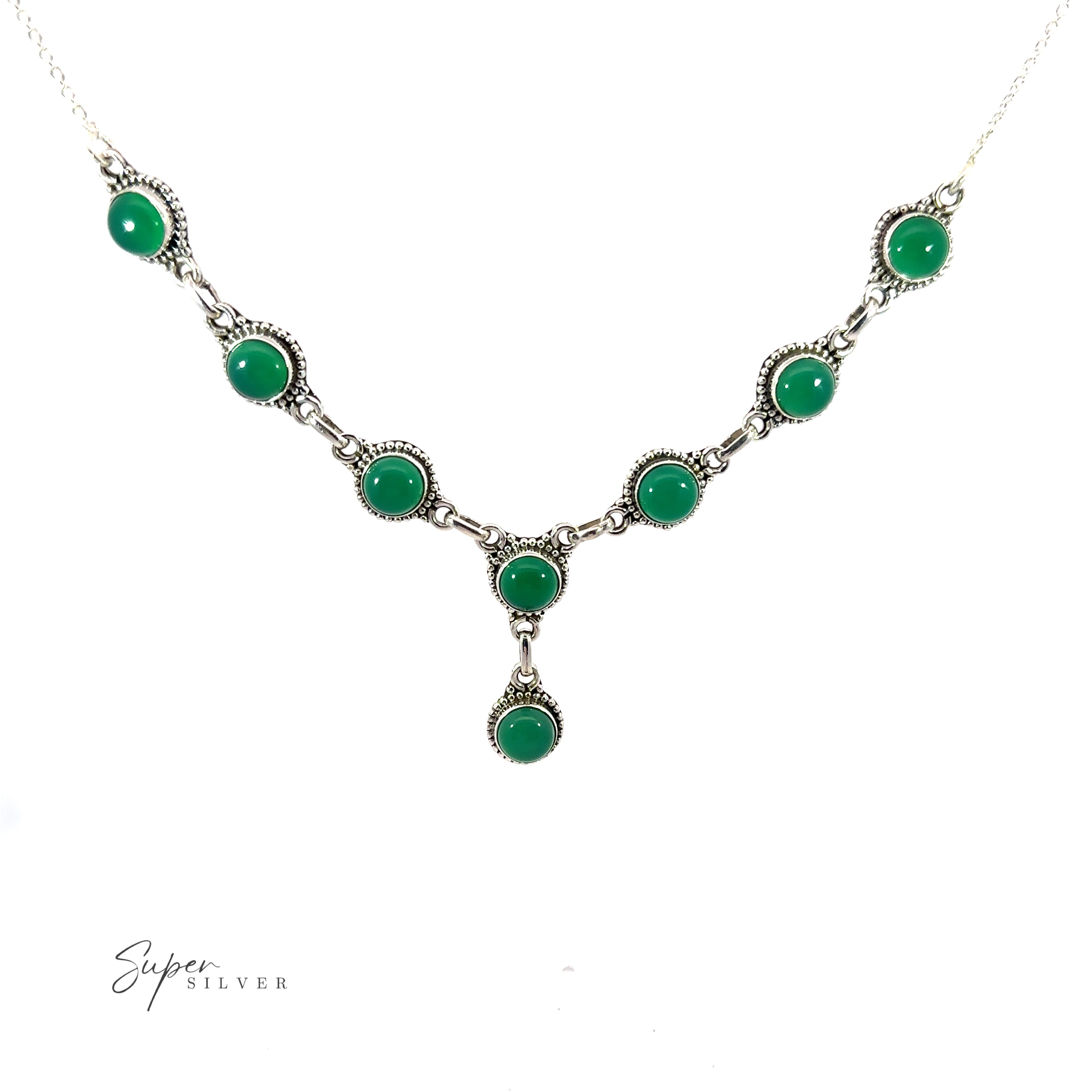 A Round Gemstone Y Necklace with Ball Border with green gemstones in round settings, featuring a central drop pendant. This bohemian style jewelry piece is elegantly labeled "Super Silver" in the bottom left corner.