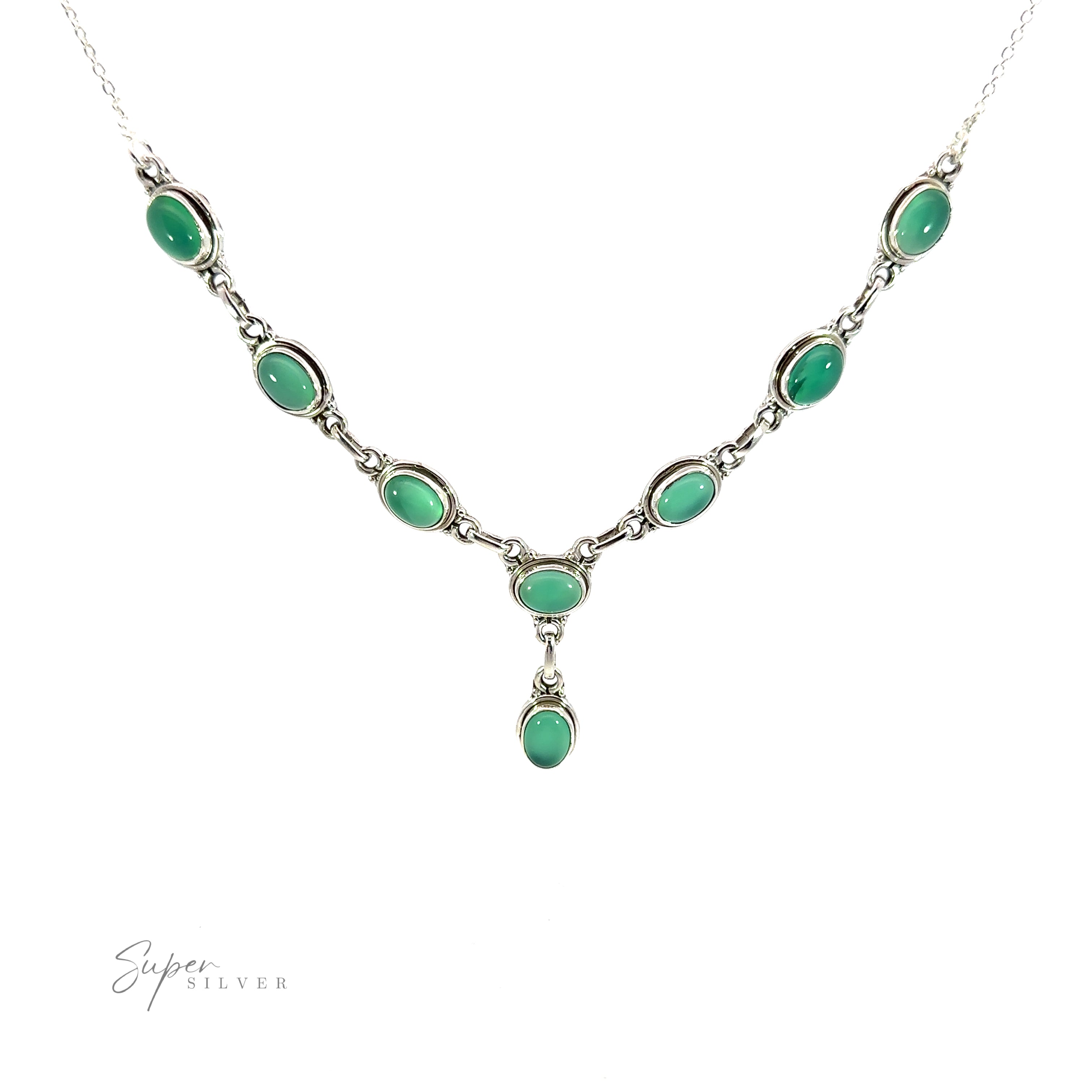 A silver Simple Oval Y Necklace with Gemstones featuring eight green oval gemstones evenly spaced along the chain with a single hanging green oval stone in the center. The "Super Silver" logo is on the bottom left corner, adding a touch of bohemian charm to this elegant piece.