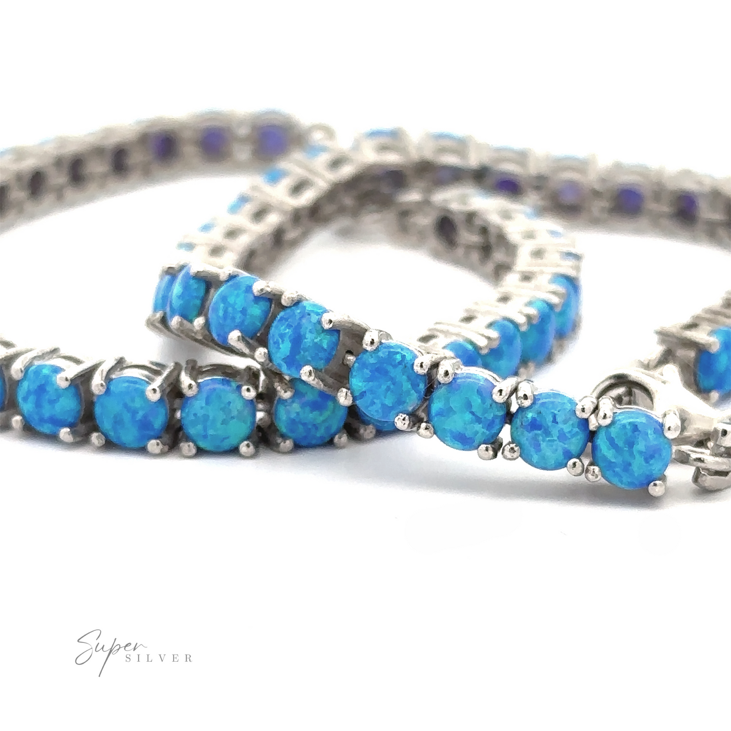 Brilliant Blue Opal Bracelet adorned with bright blue lab-created opal stones, closely interconnected, arranged on a white surface, showing detailed craftwork.
