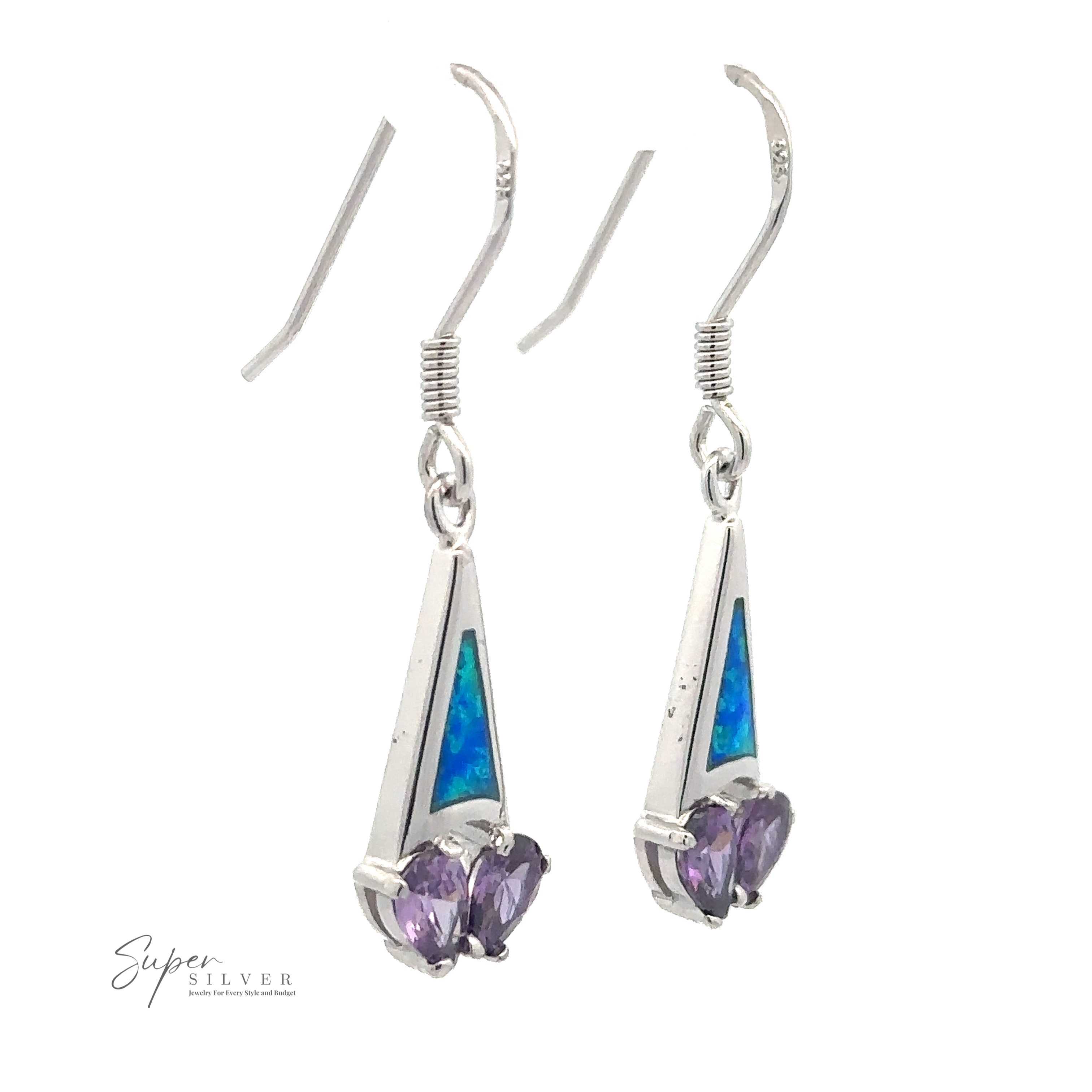 A pair of rhodium-plated sterling silver drop earrings with purple heart-shaped CZ stones and blue triangular inlays. The hooks have a simple design, and "Created Opal Earrings with Purple Cubic Zirconia" is branded at the bottom left corner.