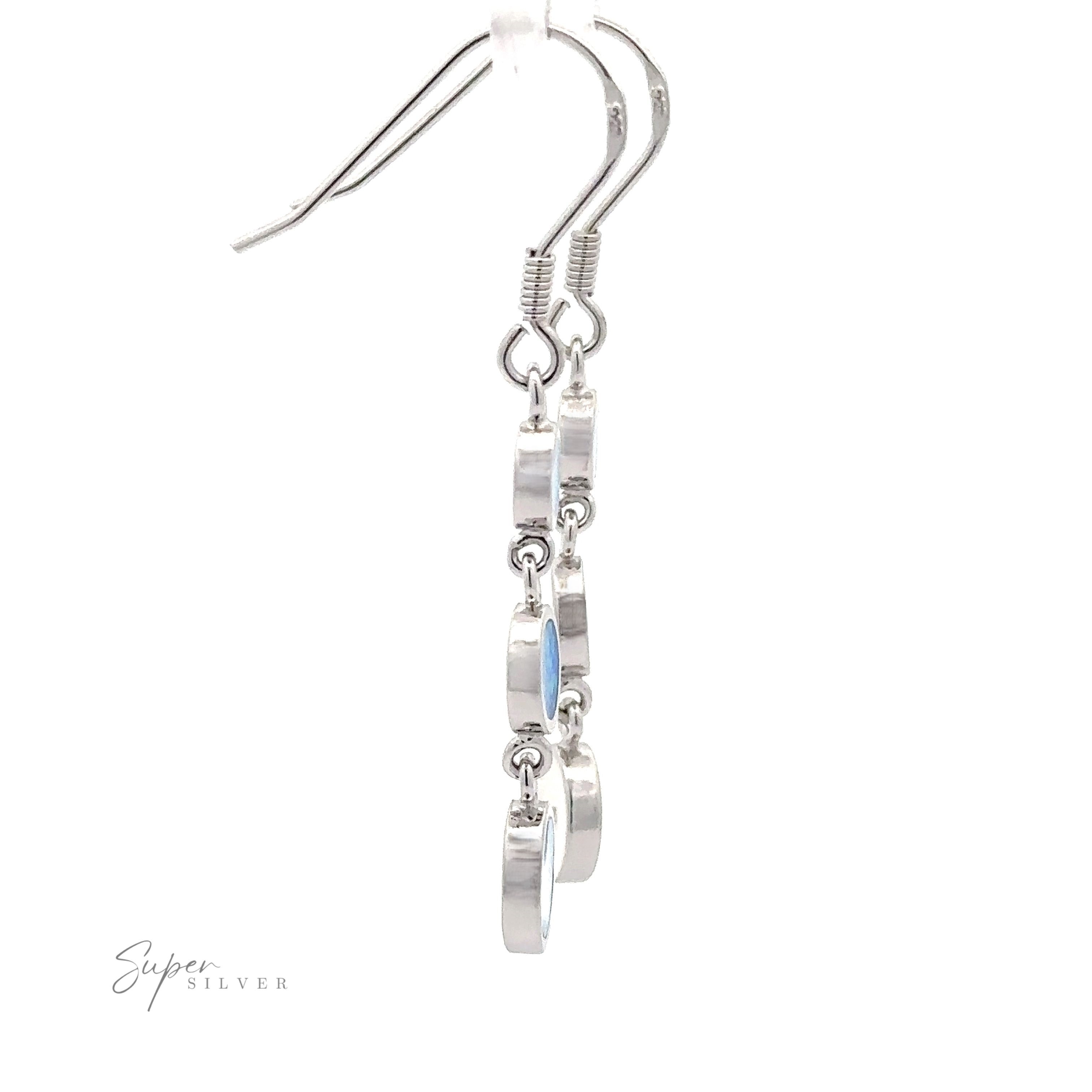 Introducing the Long Oval Blue Lab-Created Opal Earrings, characterized by five circular links hanging in a vertical sequence with an exquisite geometric design. The blue lab-created opal adds a touch of elegance, making these sterling silver drop earrings a stunning statement piece. Displayed on a white background, they are sure to impress.