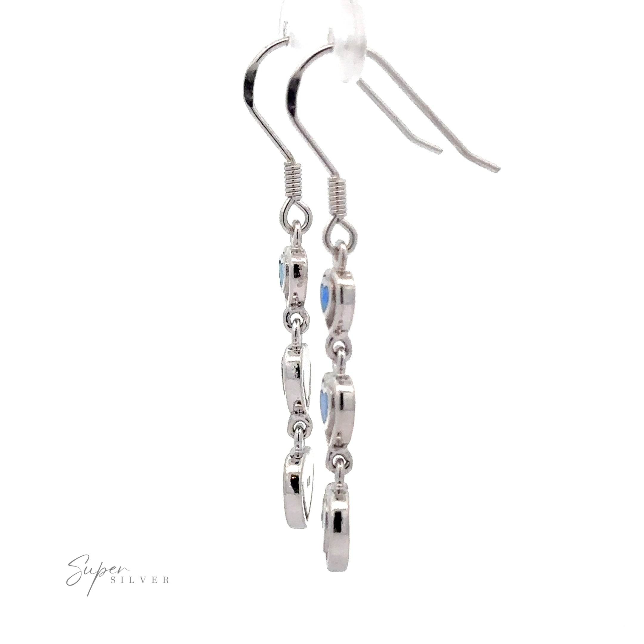 A pair of Dangling Lab-Created Opal Heart Earrings with multiple circular charms hanging in a vertical line. Branded "Super Silver" in the bottom left corner, these earrings are reminiscent of elegant sterling silver designs.