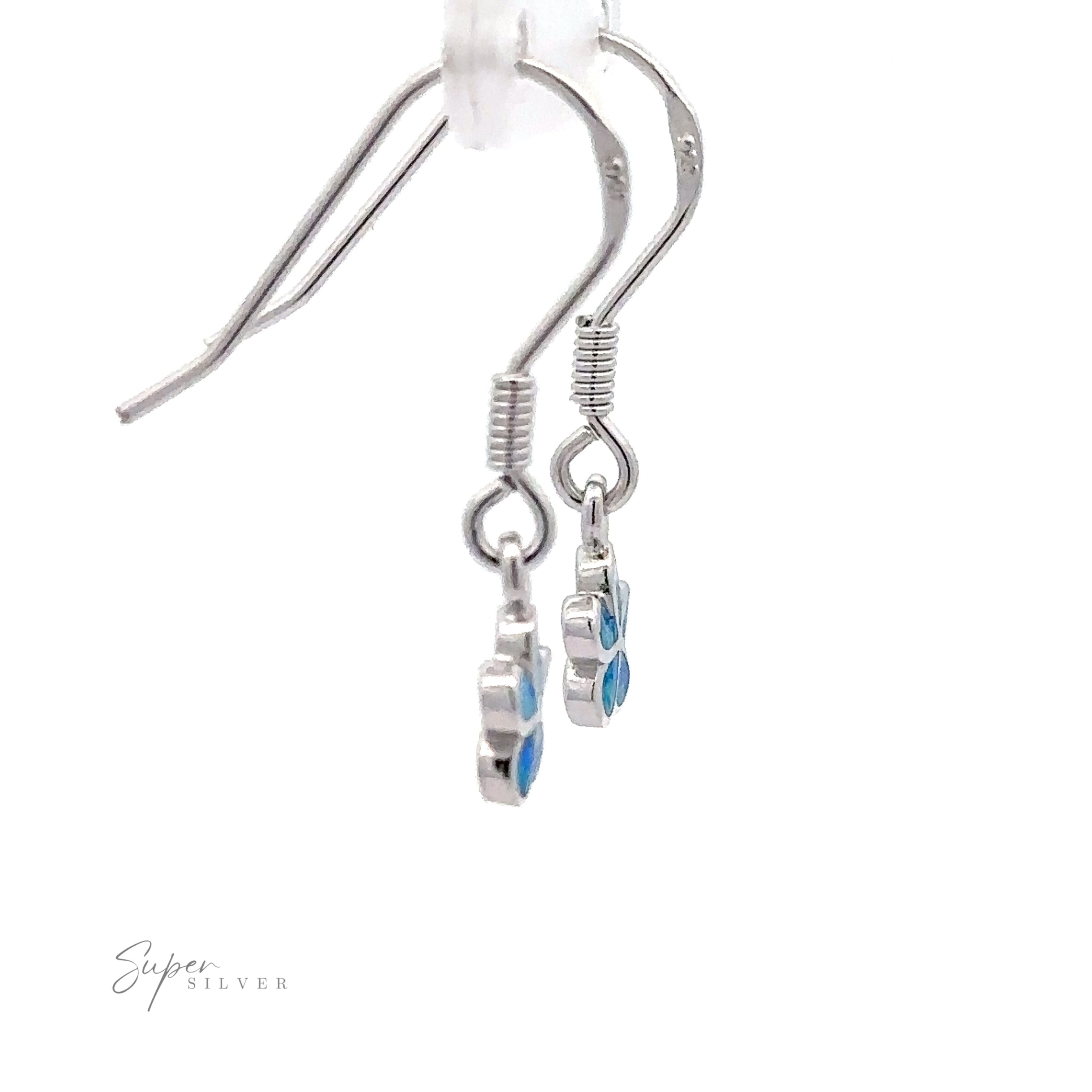 Close-up of Small Plumeria Flower Lab-Created Opal Earrings, featuring sterling silver with small blue flower-shaped charms hanging from hooks against a white background. The text "Super Silver" is present at the bottom left corner.