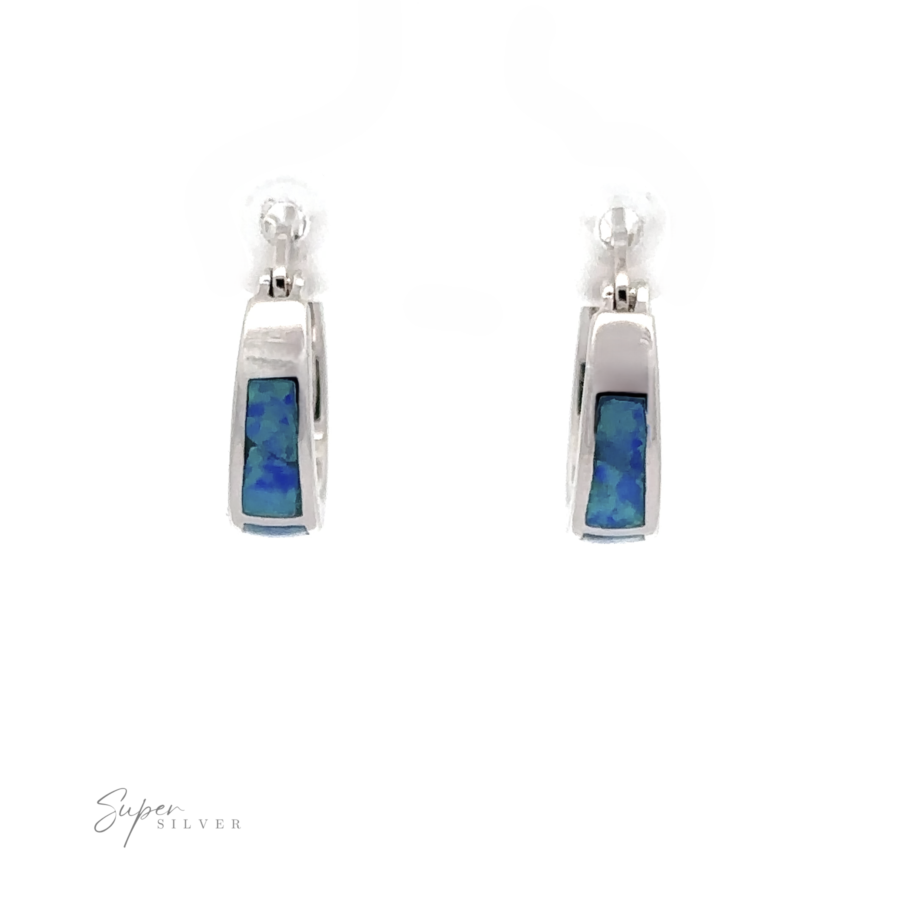The Blue Lab-Created Opal Huggie Hoop Earrings, featuring rectangular blue and green iridescent stones at the center and enhanced with a rhodium finish, are displayed against a white background.
