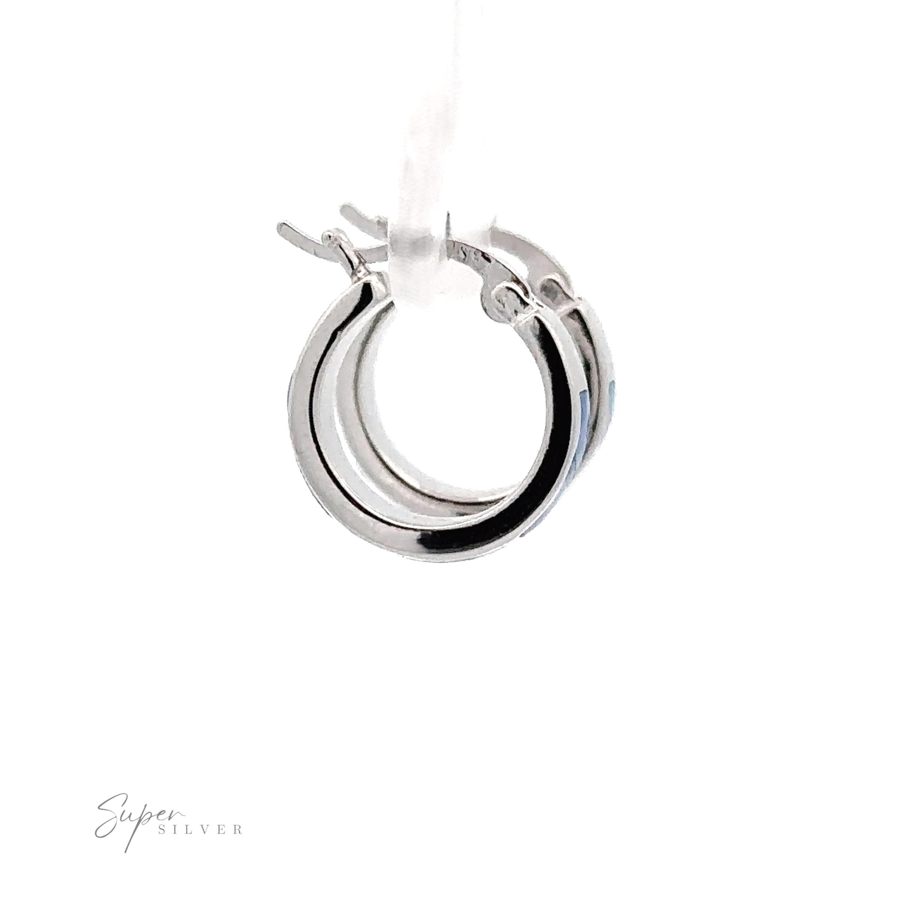 Close-up of a pair of small, polished Blue Lab-Created Opal Huggie Hoop Earrings with a rhodium finish and latch-back closure, displayed on a clear stand against a white background.