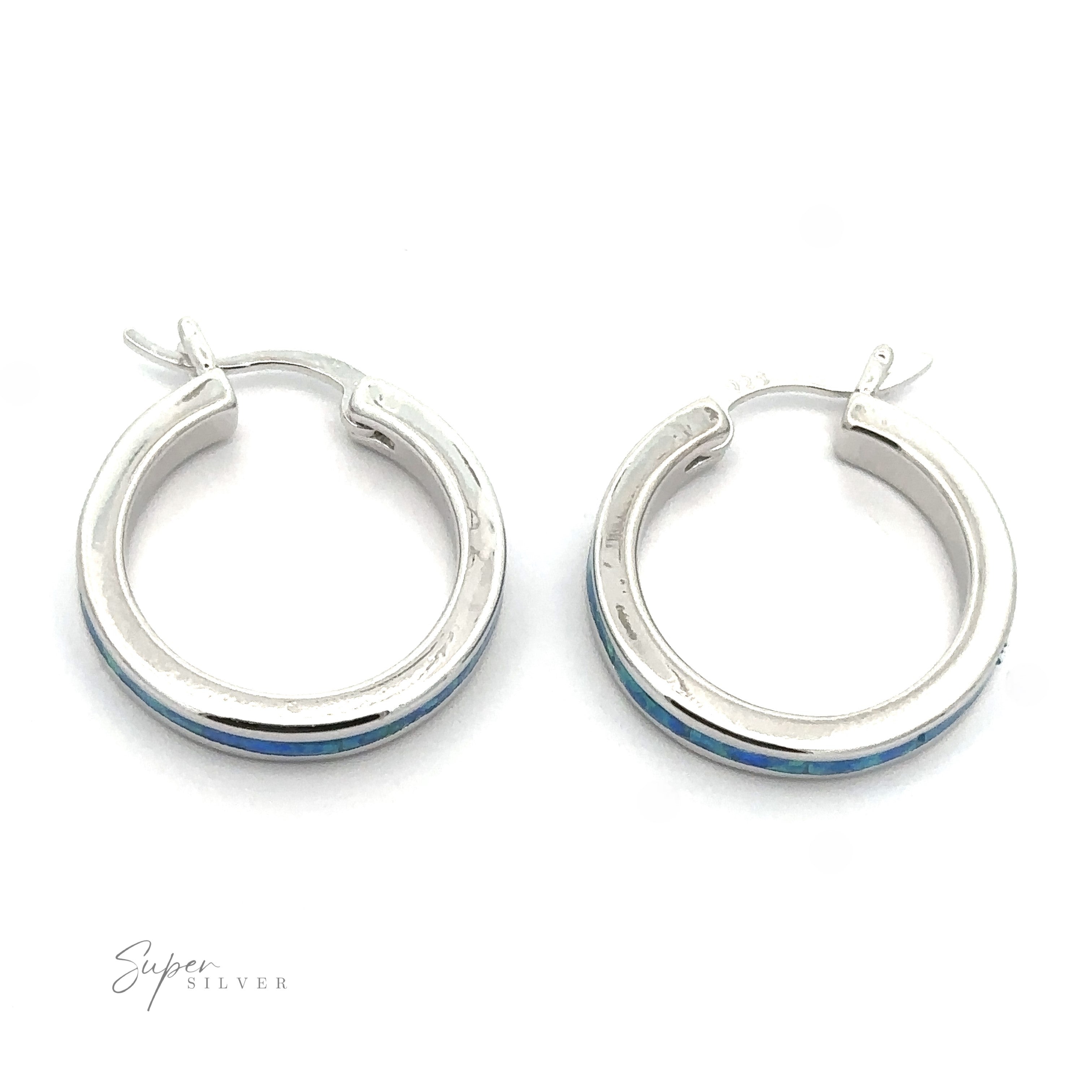 A pair of Blue Lab-Created Opal Hoop Earrings, featuring round silver hoops with a rhodium finish and a subtle blue lab-created opal accent, displayed on a plain white background.