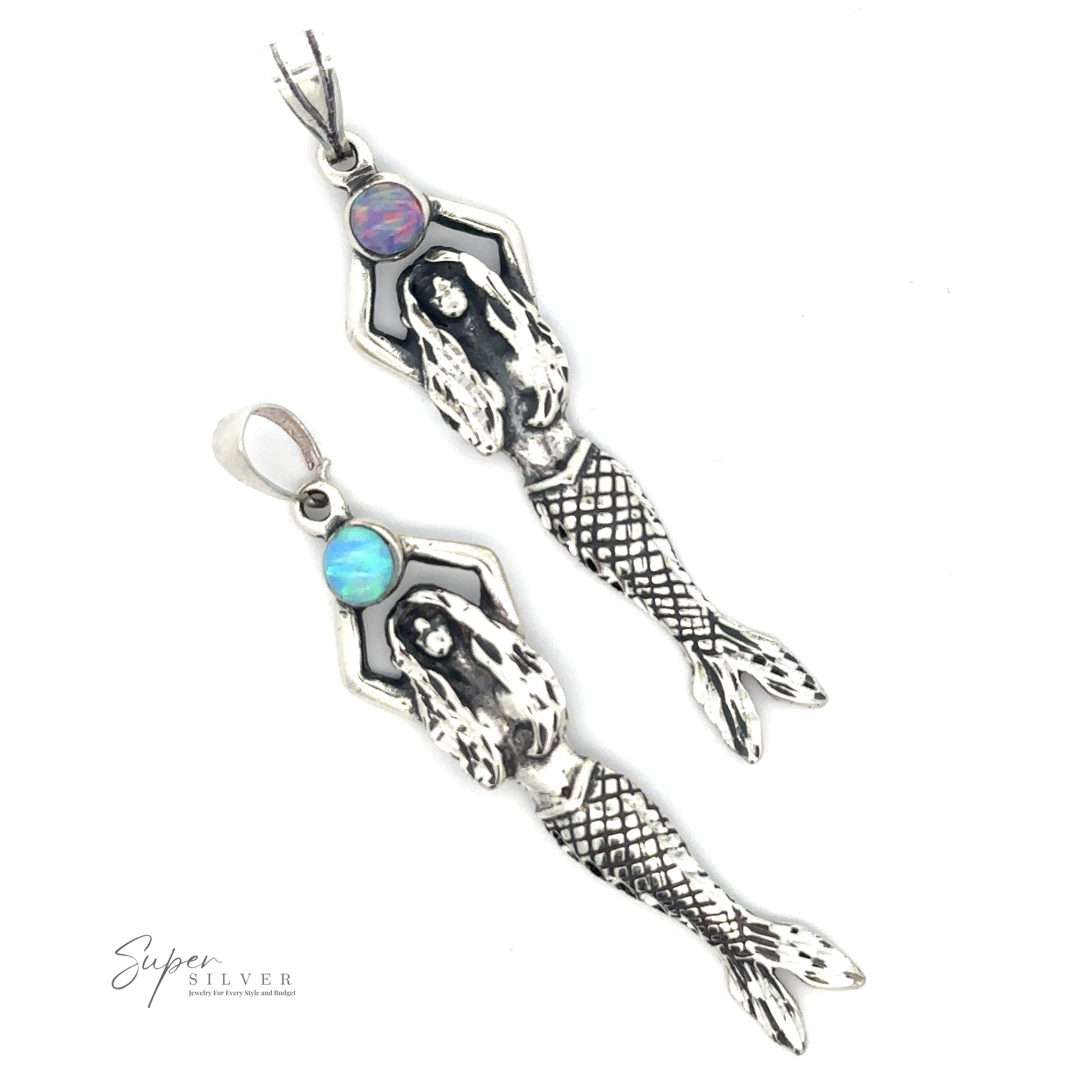 Two silver Mermaid And Opal Pendants crafted in oxidized silver with blue gemstones, featuring intricate tail and hair details. Mermaid And Opal Pendant design includes a silver Super logo in the bottom left corner.