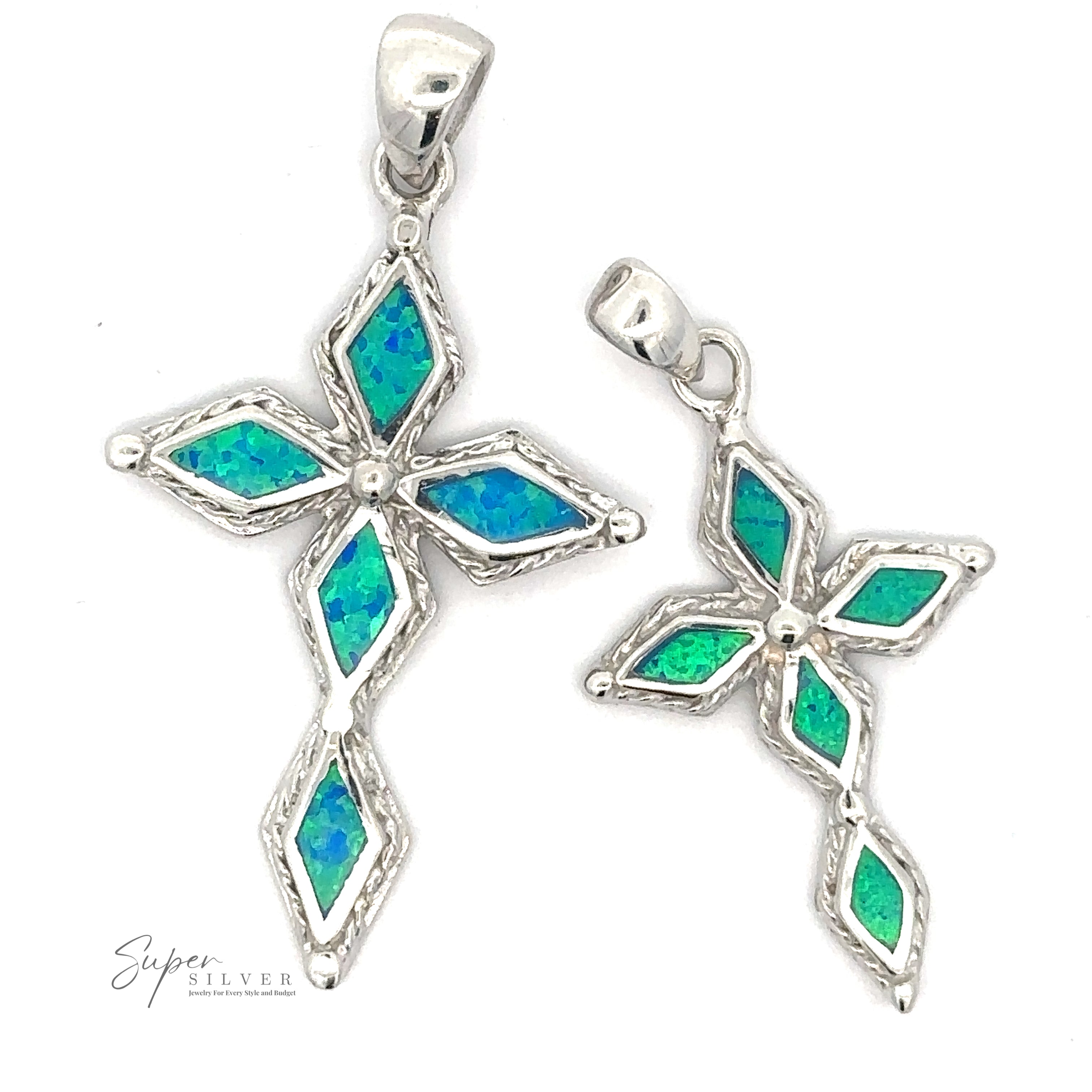 Two Blue Opal Cross Pendants shaped like stylized crosses, featuring inlaid blue and green gemstones in a geometric pattern with a striking rhodium finish.